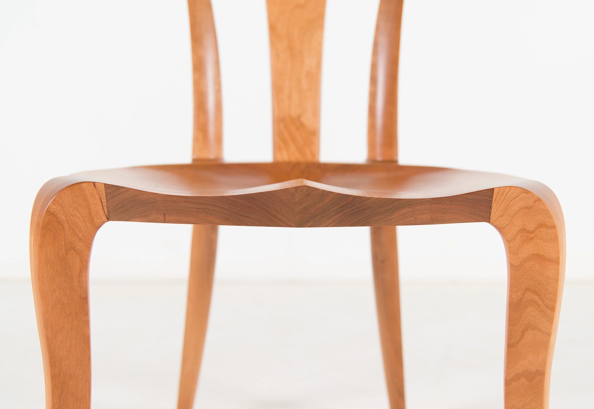 Wooden chair with a sculpted design on a white background
