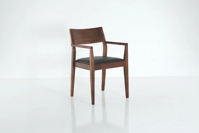 Wooden chair with a black seat on a white background