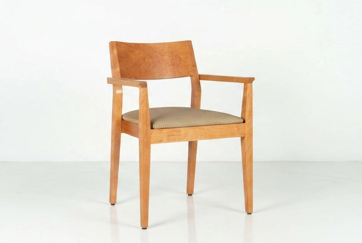 Wooden chair with a beige cushion on a white background