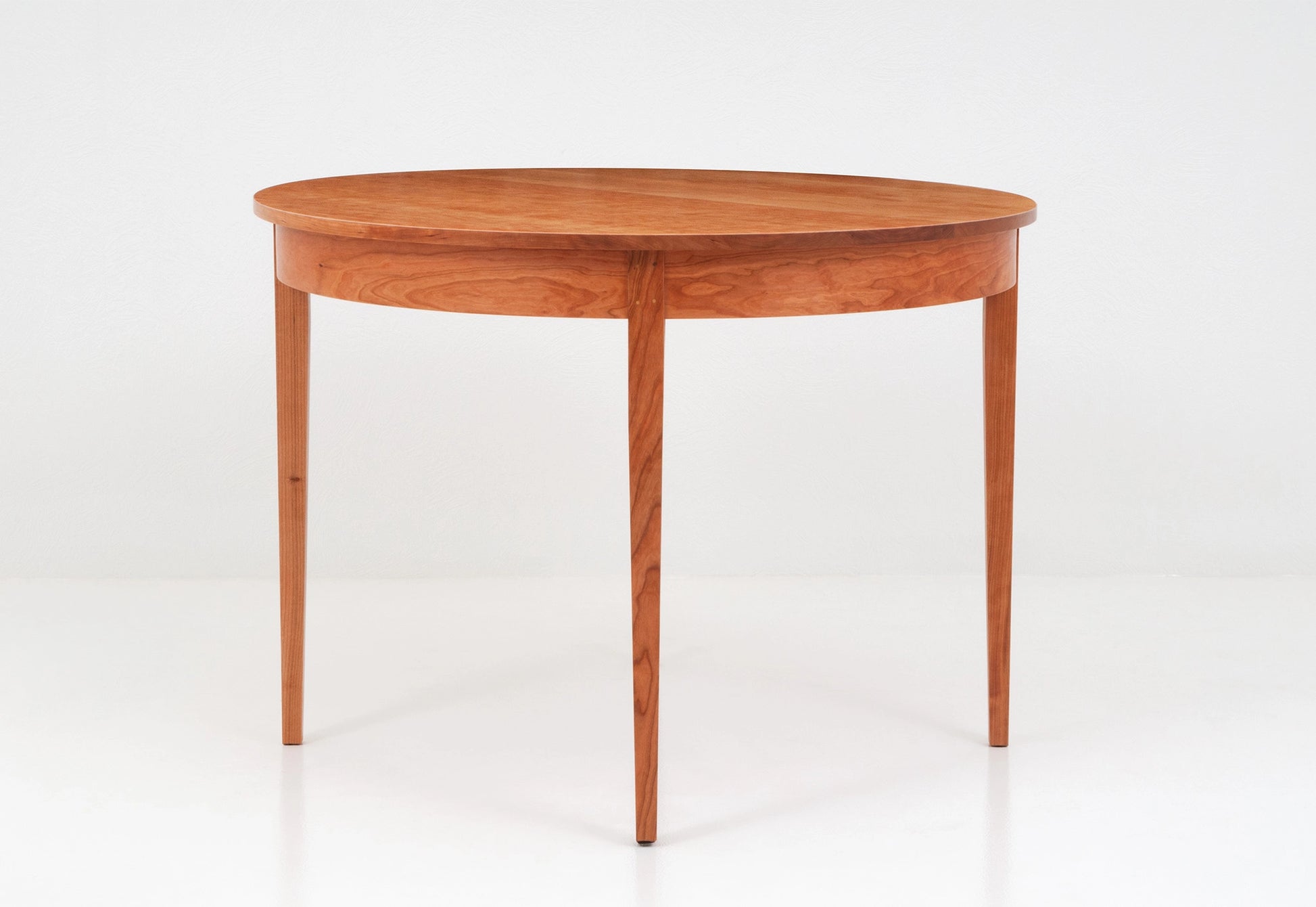 Wooden round table on a white background