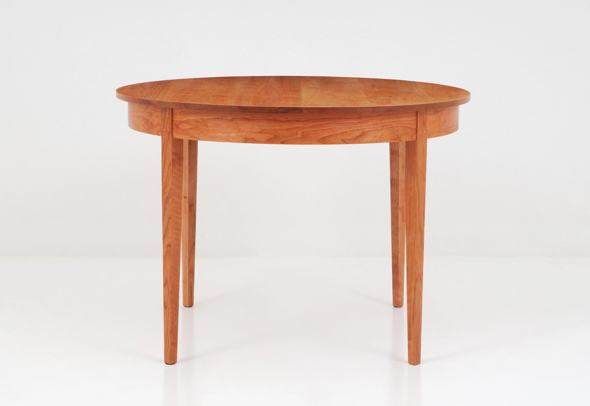Wooden round table on a white background