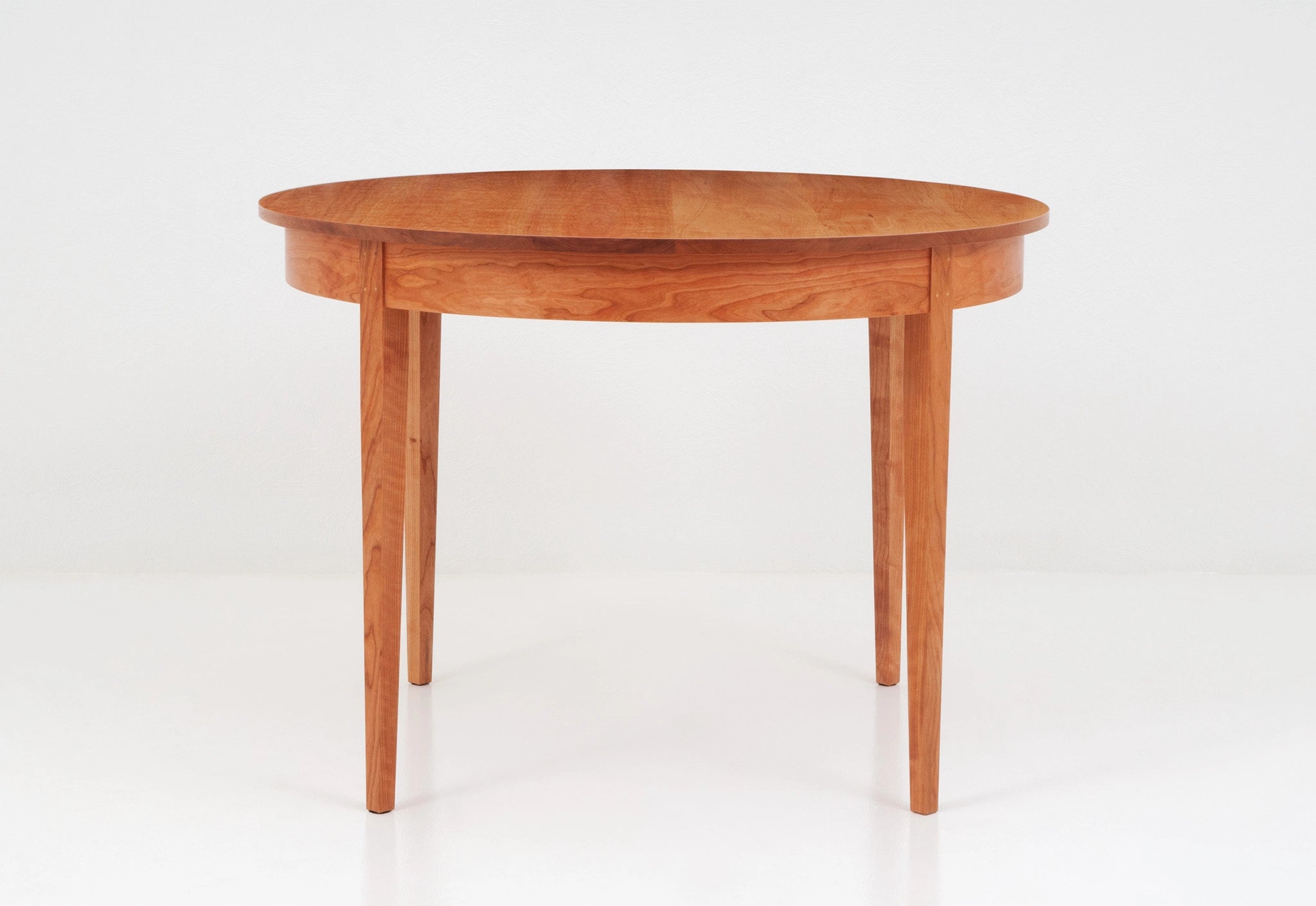 Wooden round table on a white background