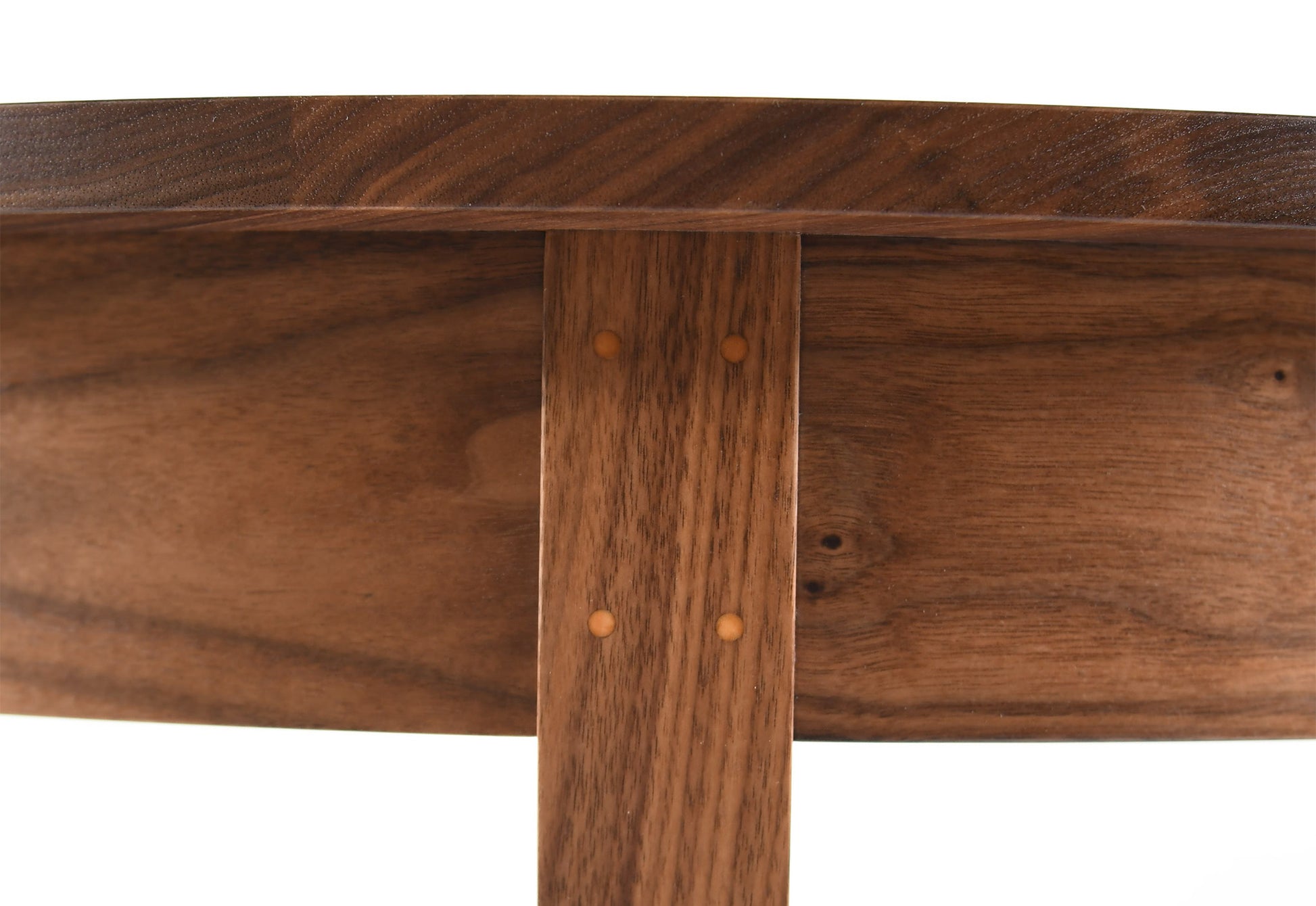 Close-up of a wooden table with a visible grain pattern on a white background