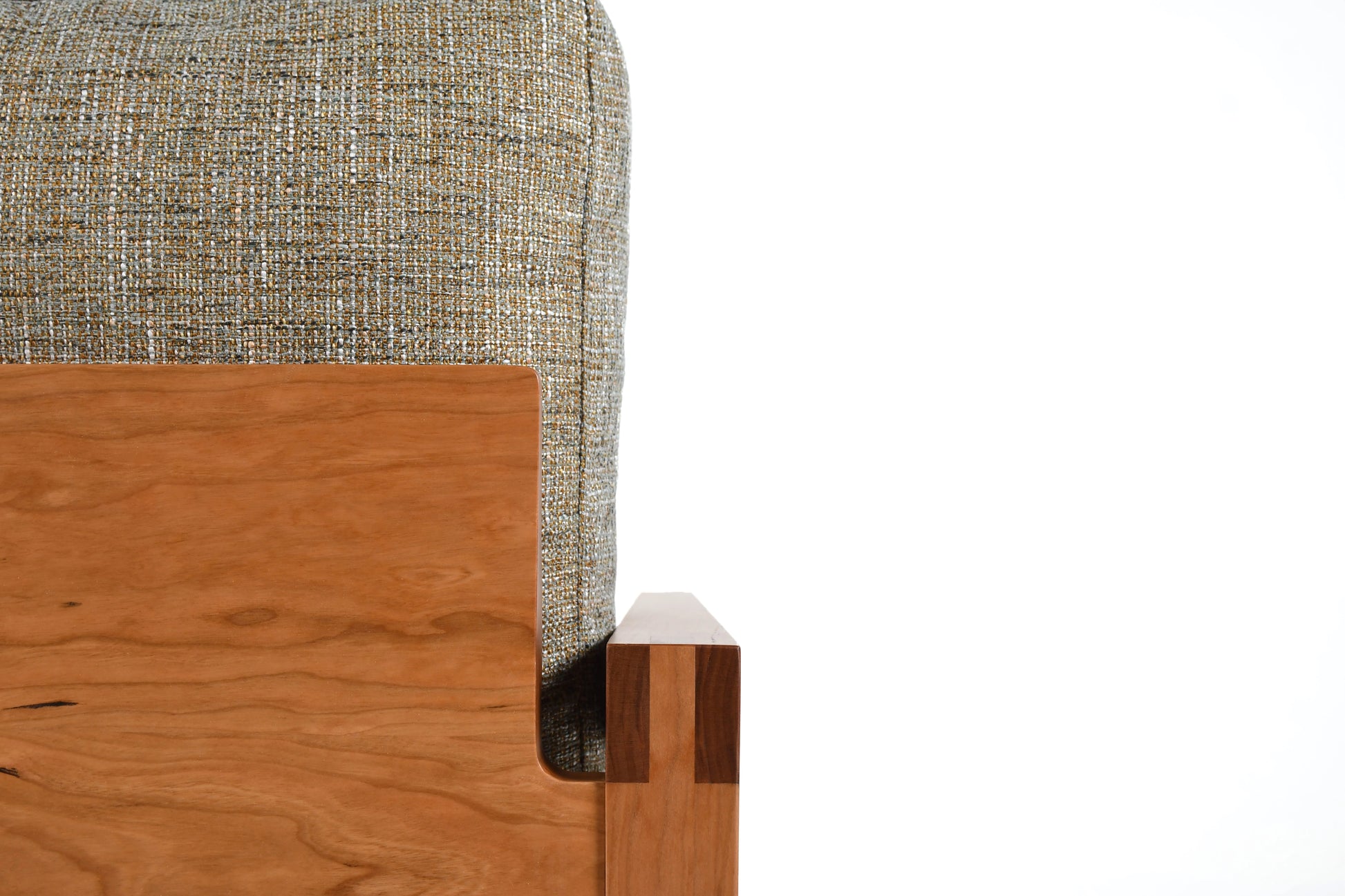 Close-up of a corner with wooden and fabric elements on a white background