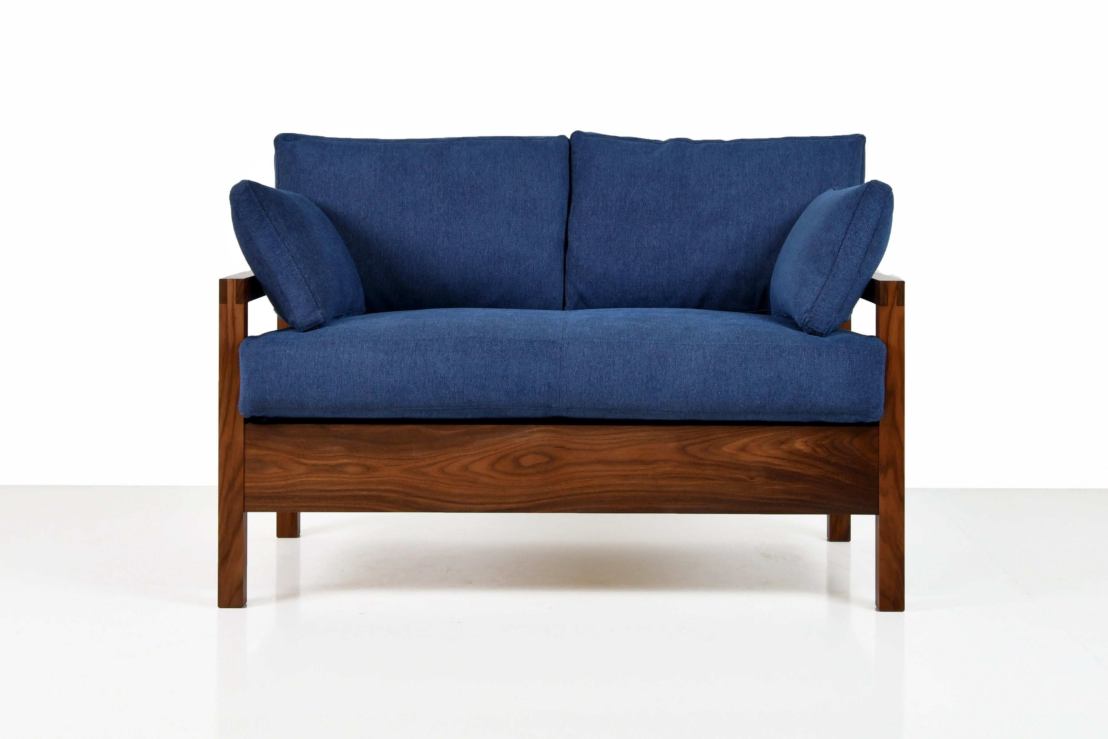Blue sofa with wooden frame on a white background