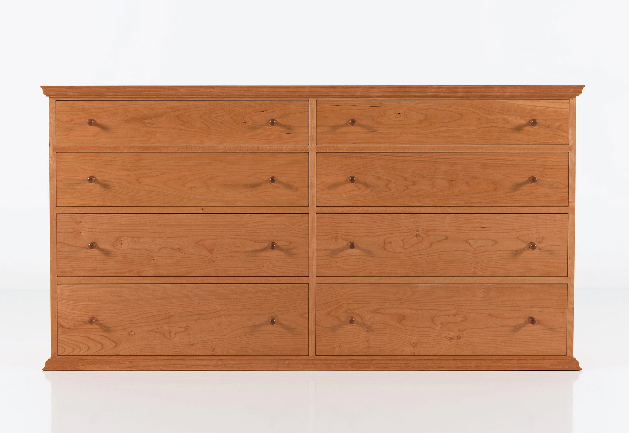 Wooden dresser with eight drawers on a white background