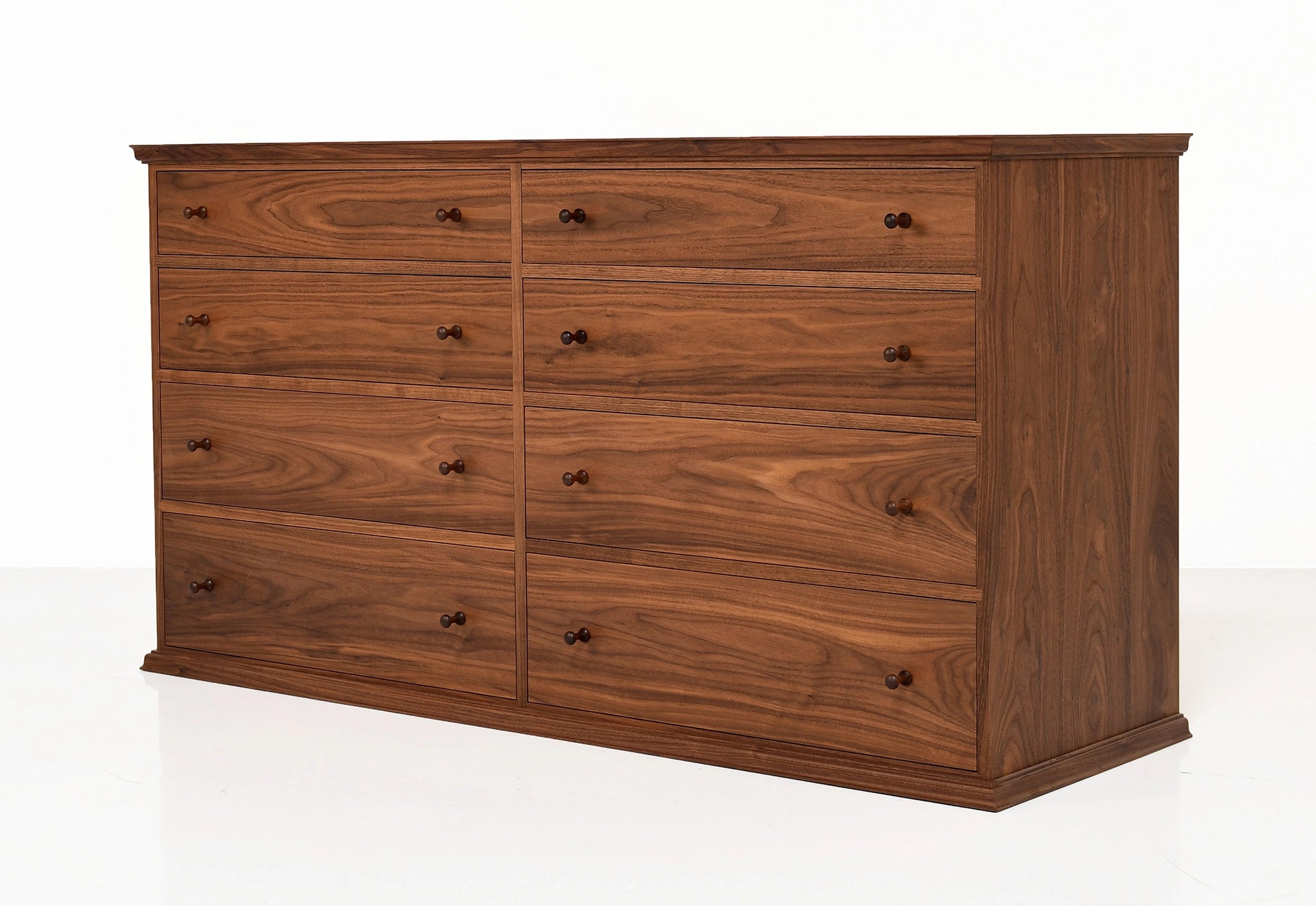 Wooden dresser with multiple drawers on a white background