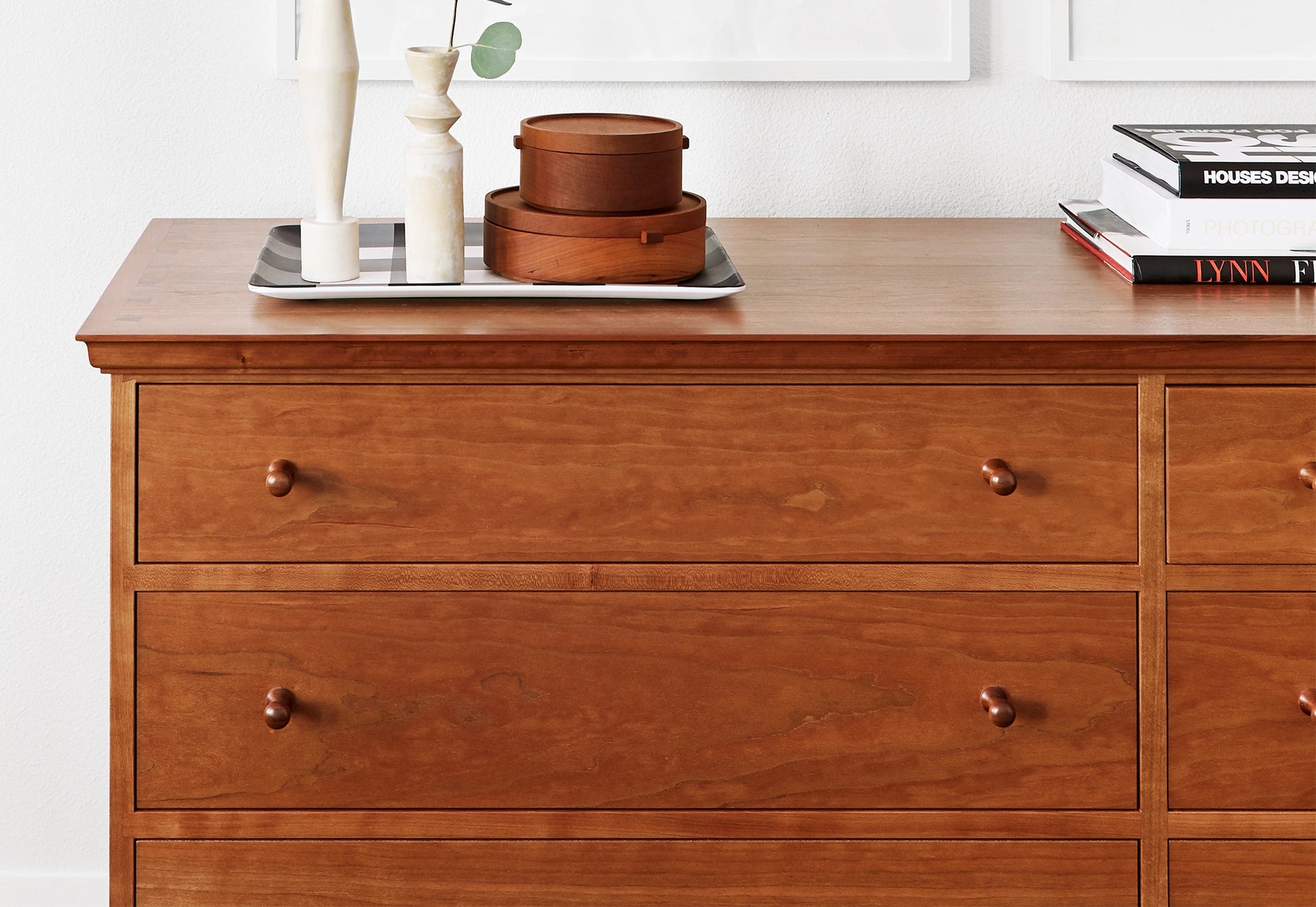 Wooden dresser with decorative items on a white background