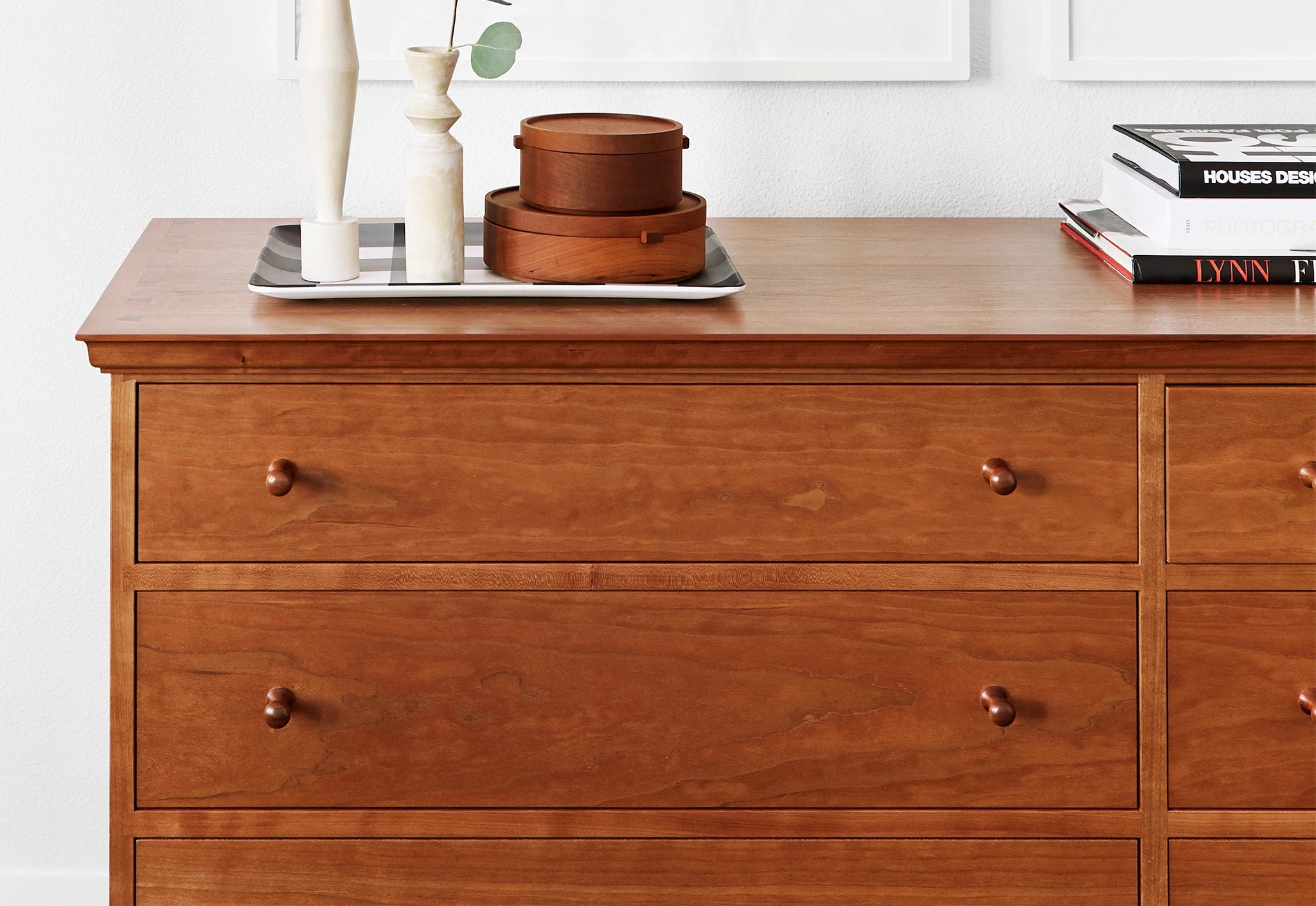 Wooden dresser with decorative items on a white background