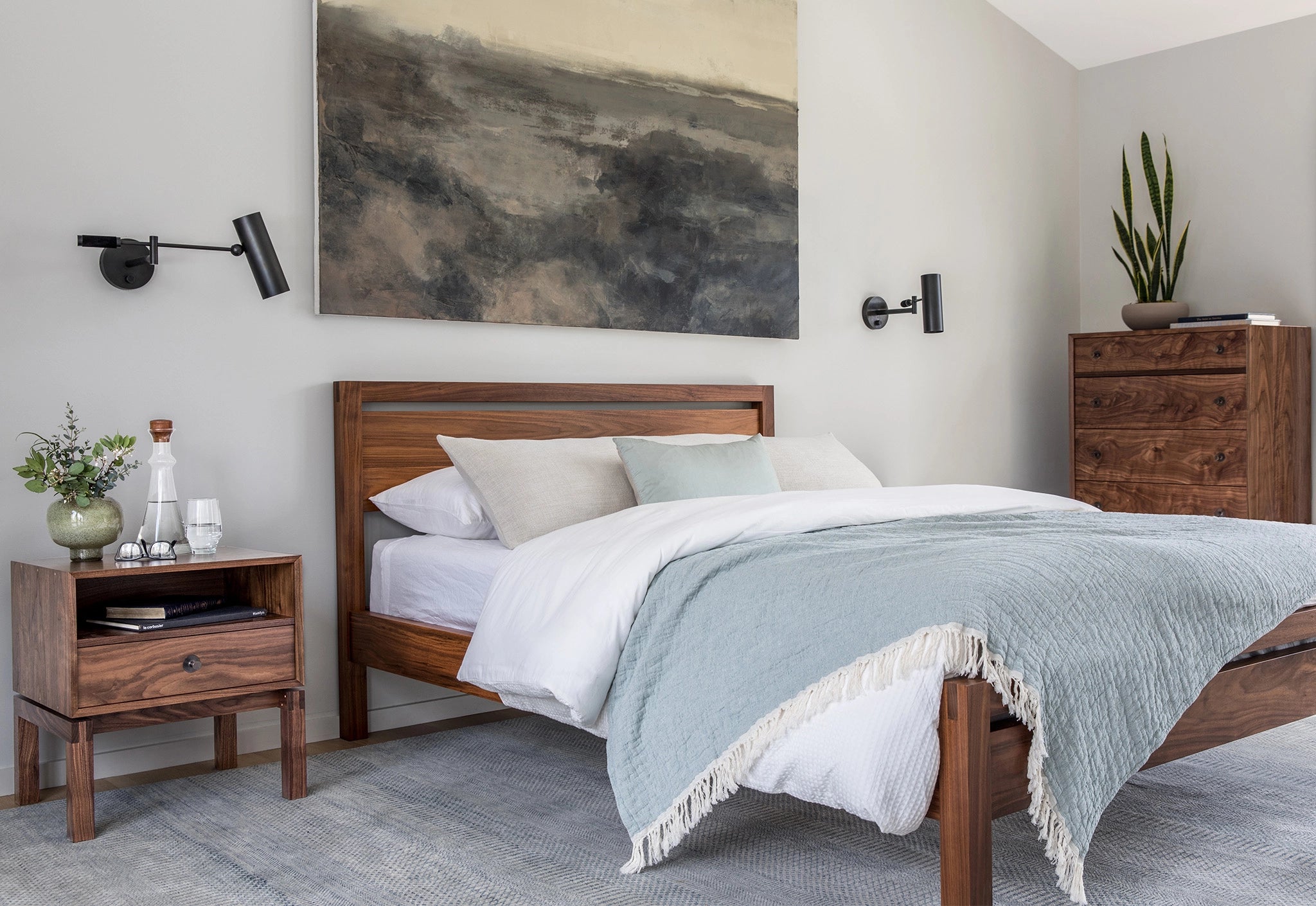 Walnut wooden bed, nightstands, and wall art