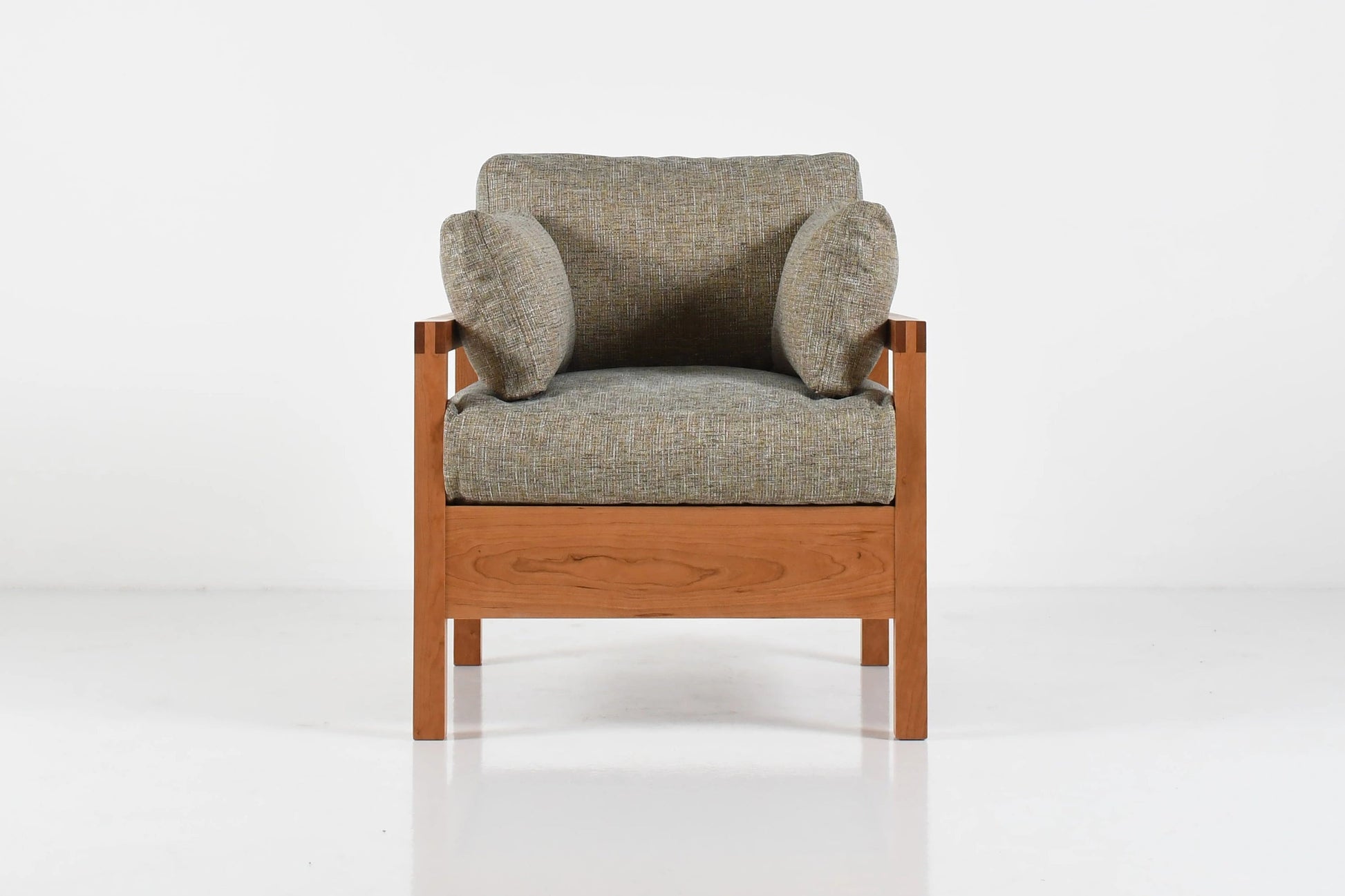 Gray armchair with wooden frame on a white background