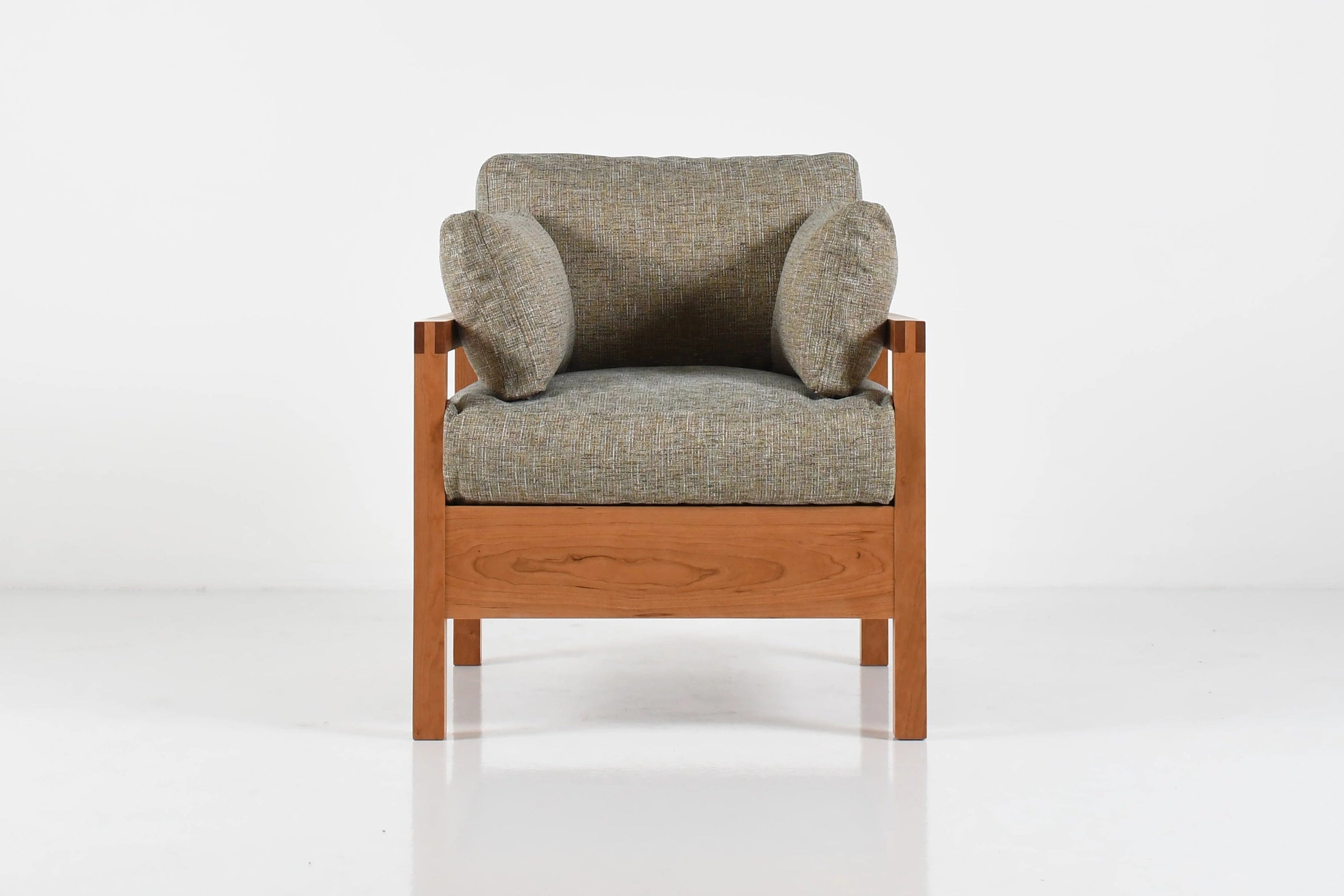 Gray armchair with wooden frame on a white background