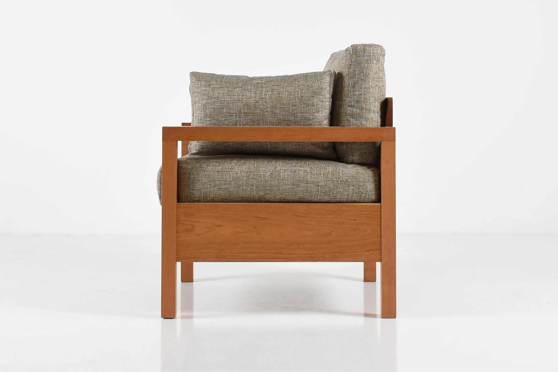 Wooden armchair with gray cushions on a white background