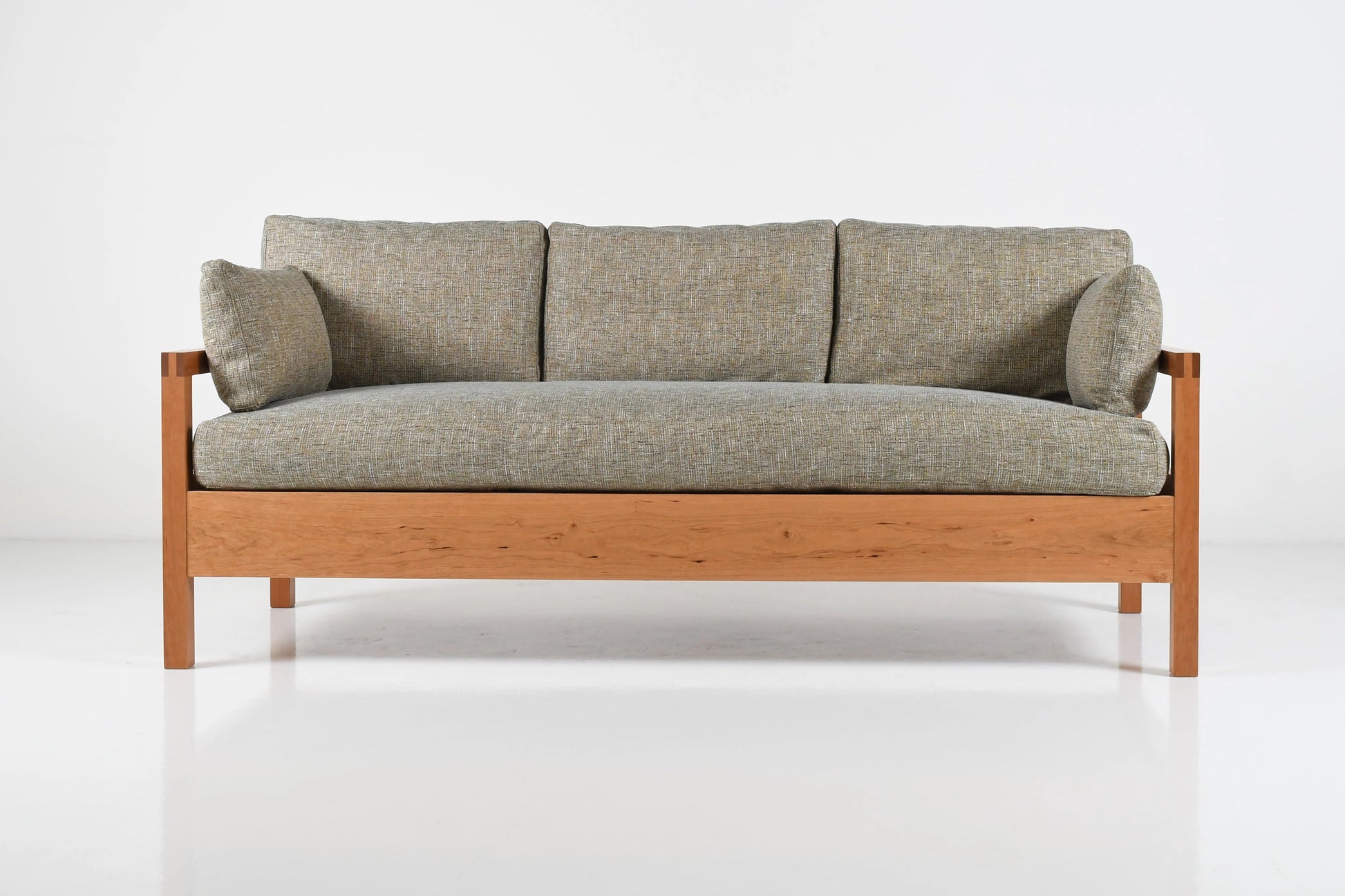 Gray sofa with wooden frame on a white background