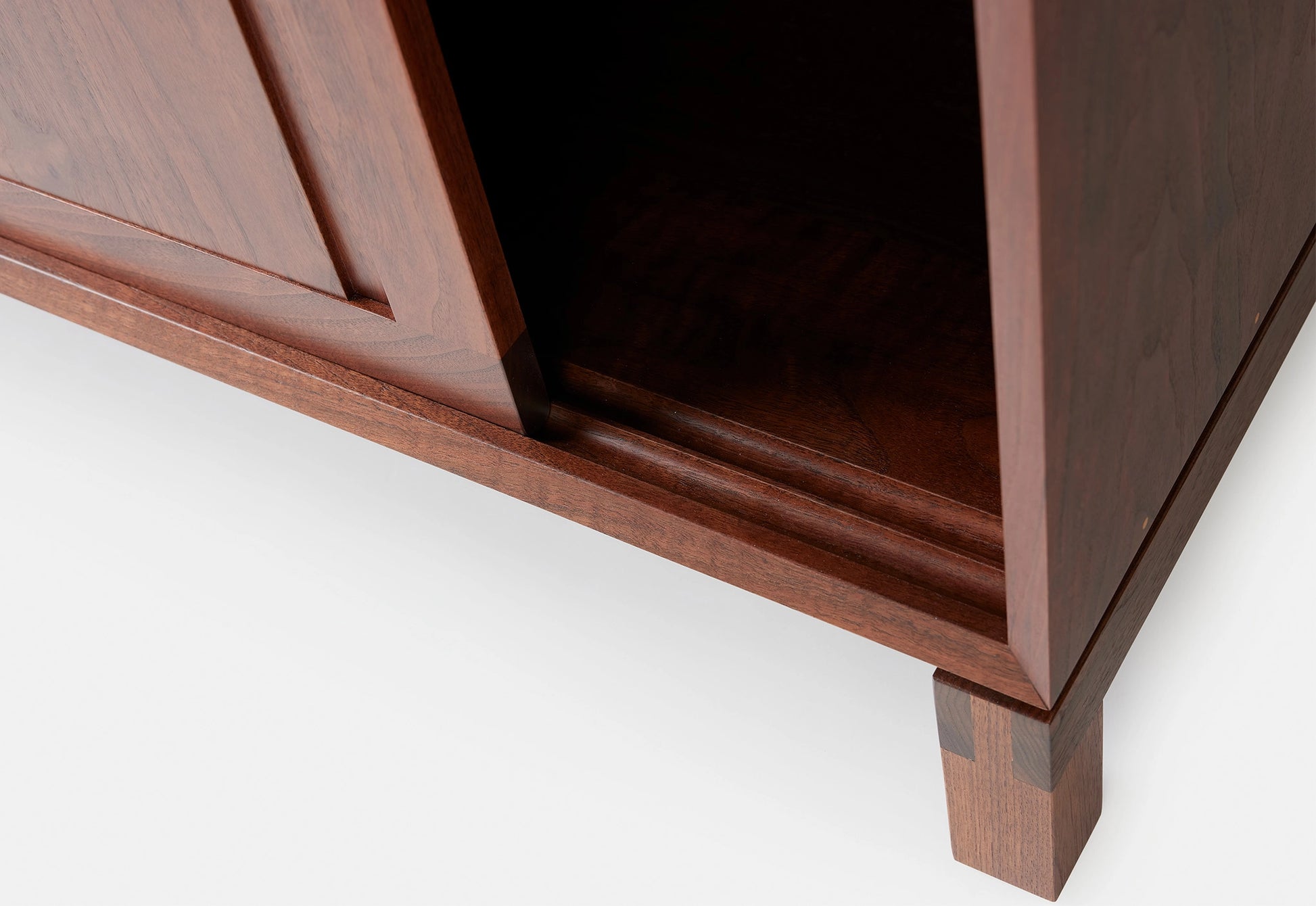Close-up of a wooden cabinet with a white background
