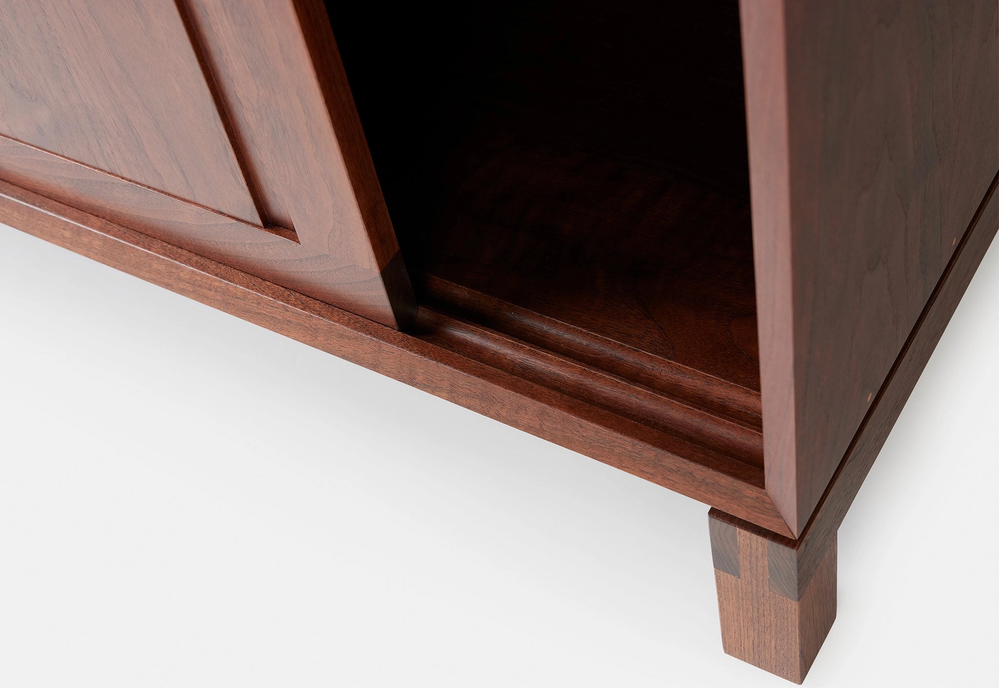 Close-up of a wooden cabinet with a white background