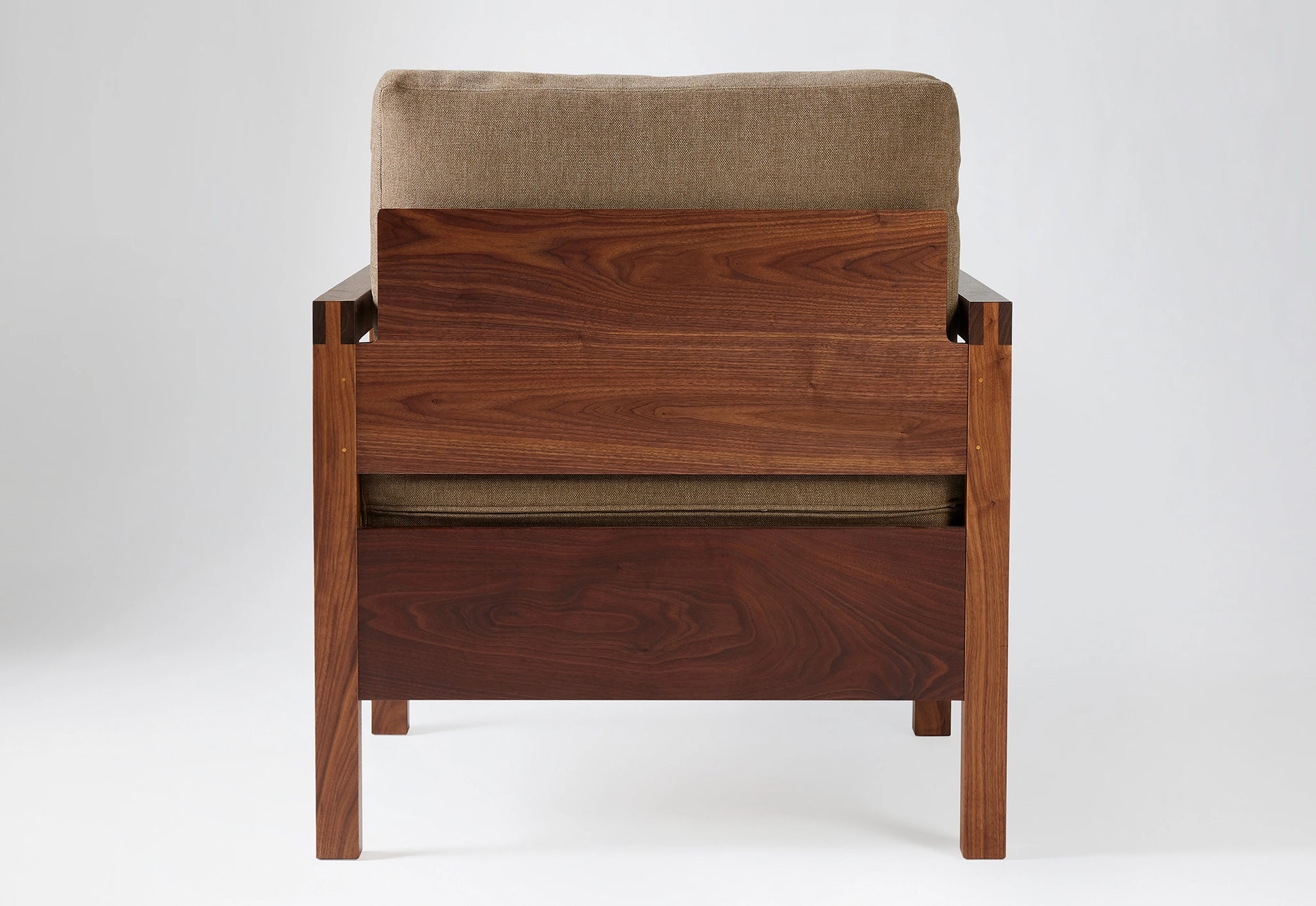 Wooden armchair with brown cushion on a white background