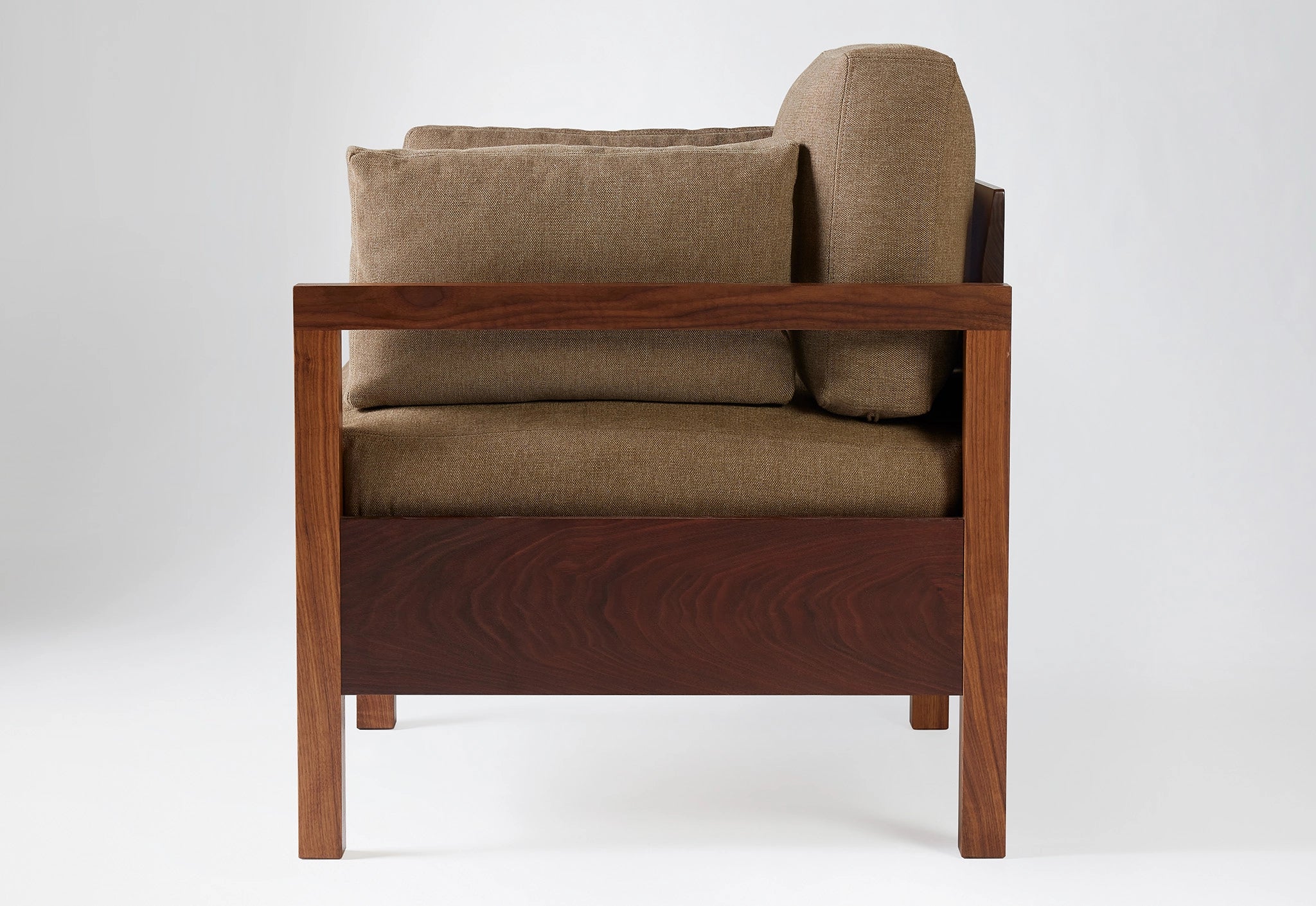 Brown armchair with wooden frame on a white background