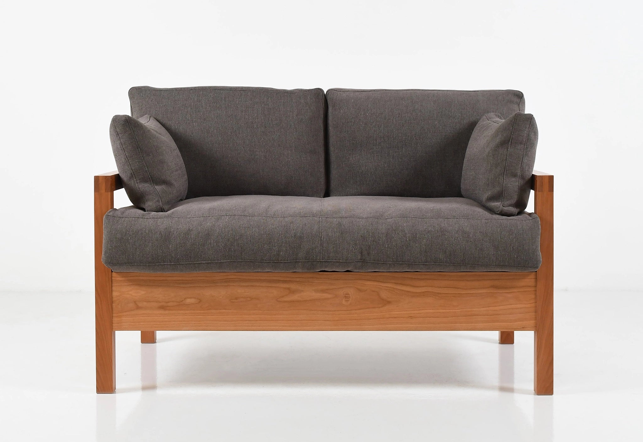 Gray sofa with wooden frame on a white background