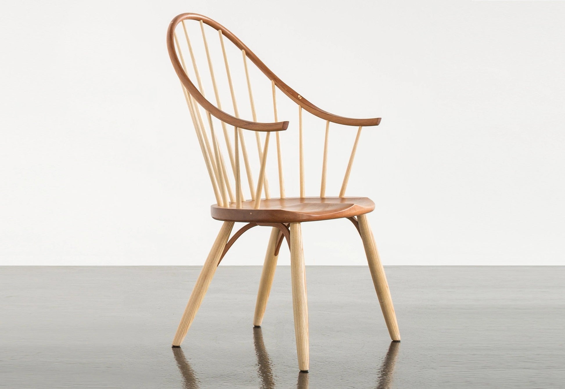 Wooden chair with a minimalist design on a gray floor and white background