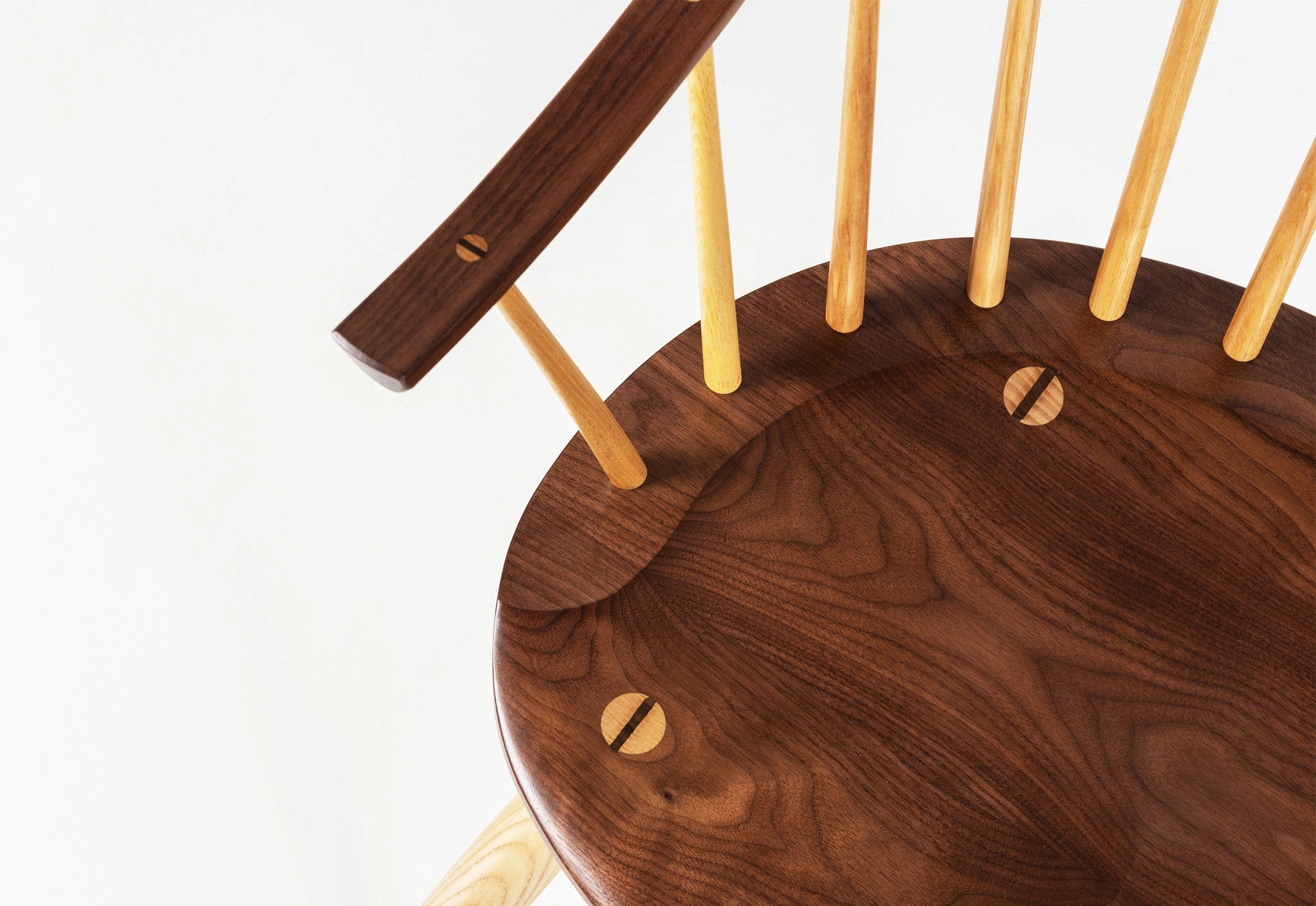 Close-up of a wooden chair with a focus on the seat and backrest.