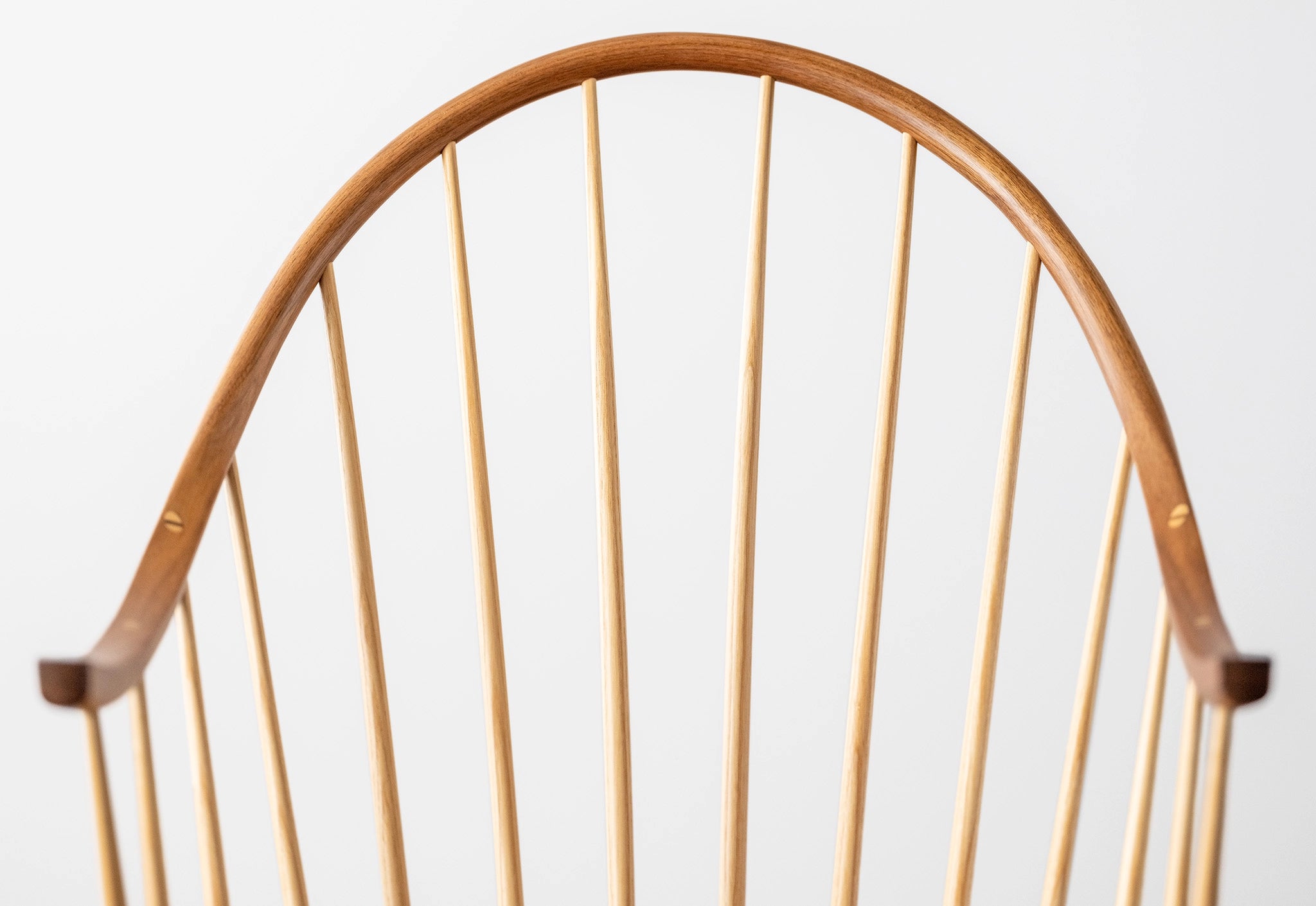 Close-up of a wooden chair backrest on a white background