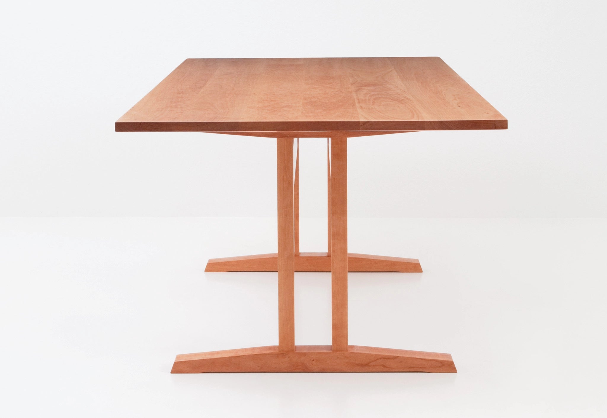 Wooden table with a minimalist design on a white background