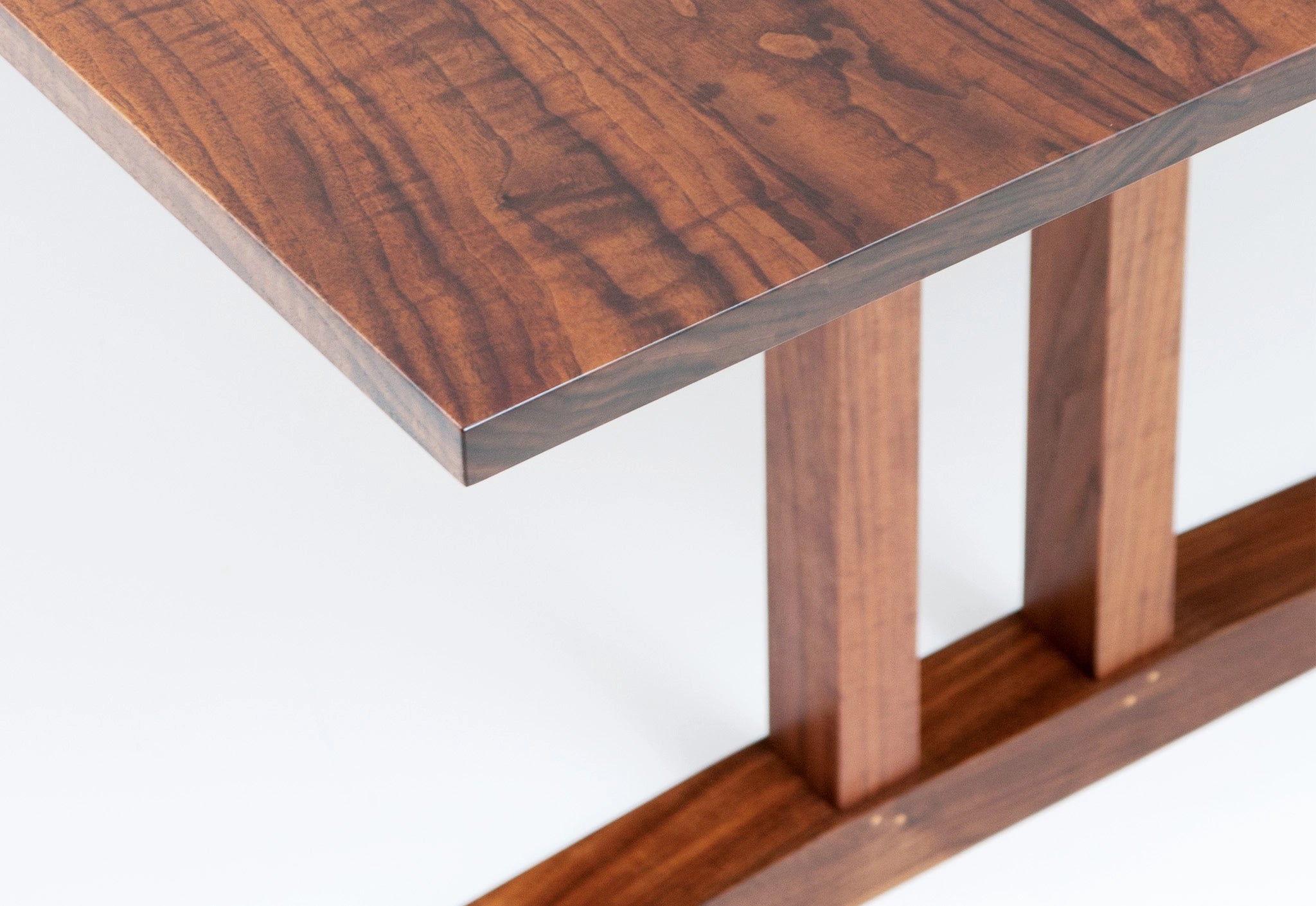 Wooden table with a focus on the top surface and base.