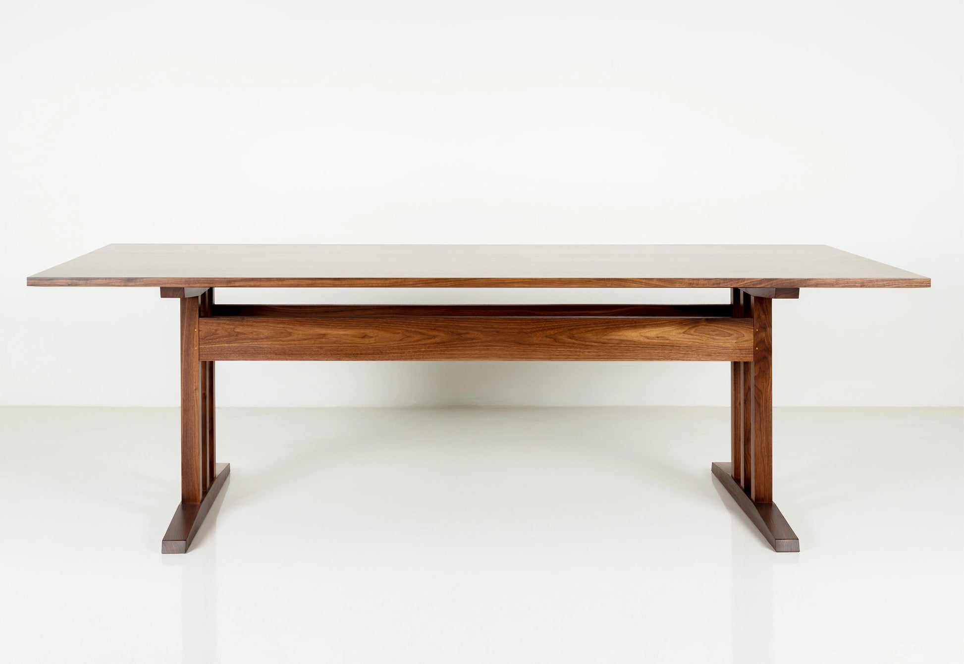 Wooden dining table with white top on a white background