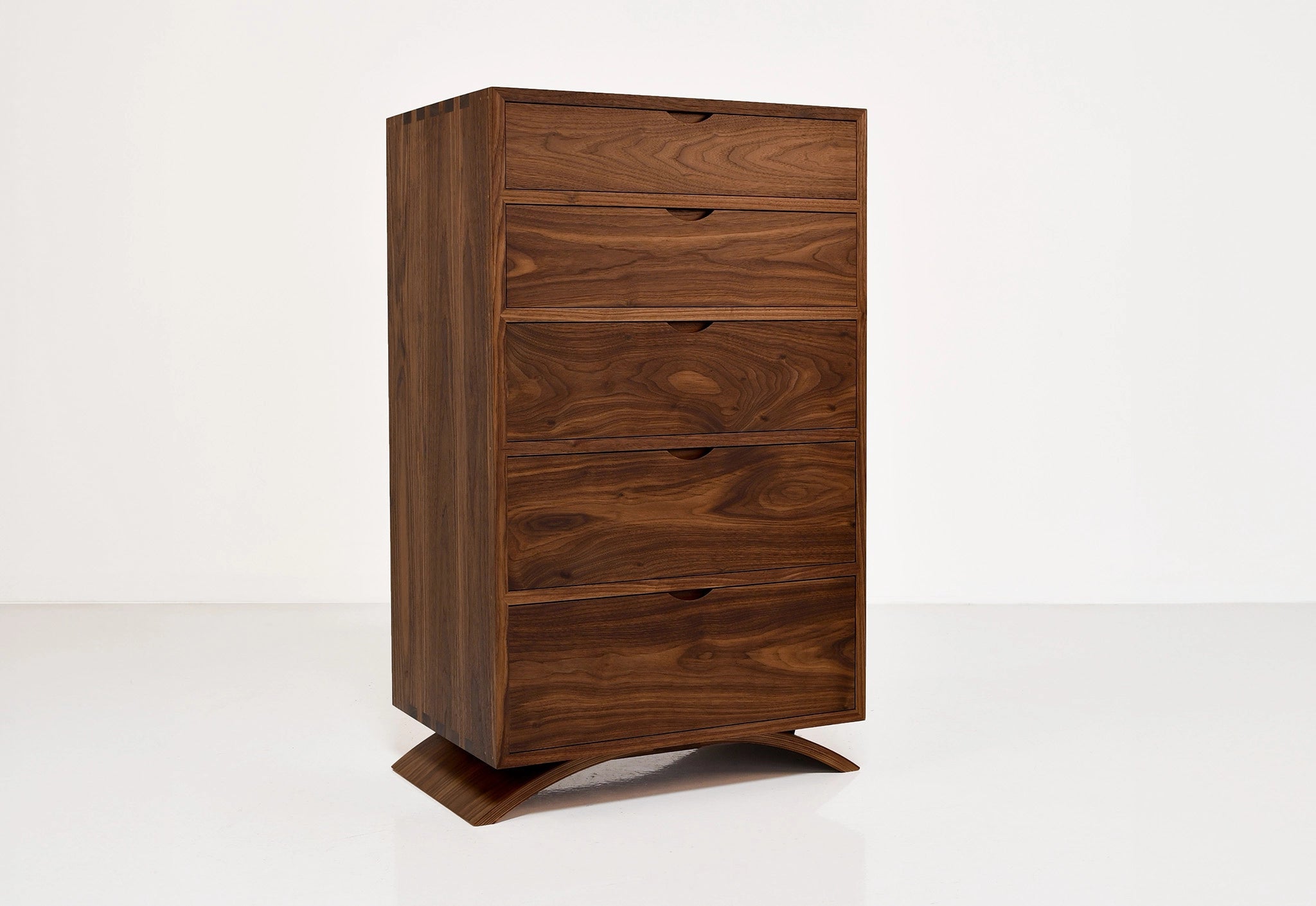 Wooden dresser with five drawers on a white background