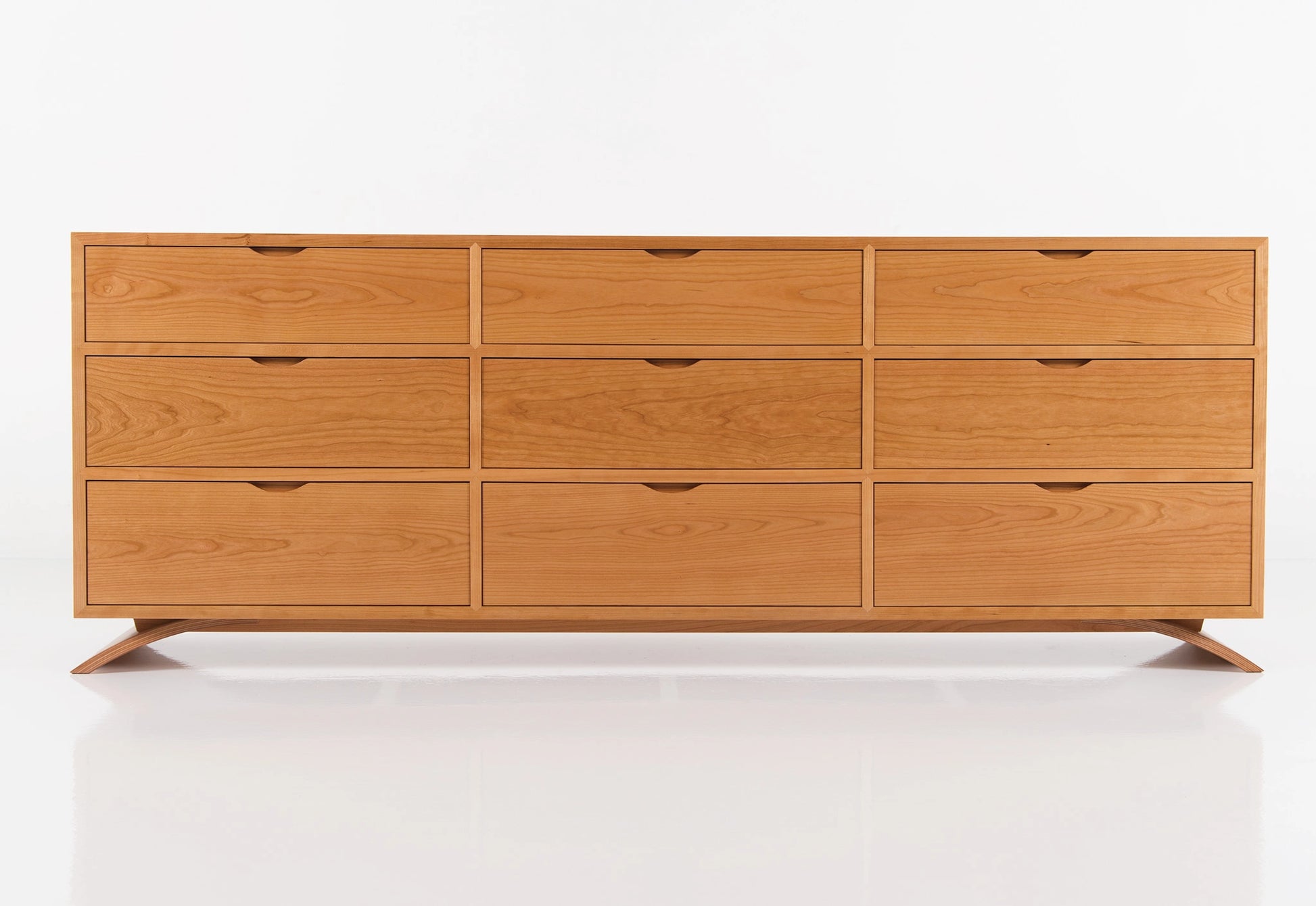 Wooden dresser with multiple drawers on a white background