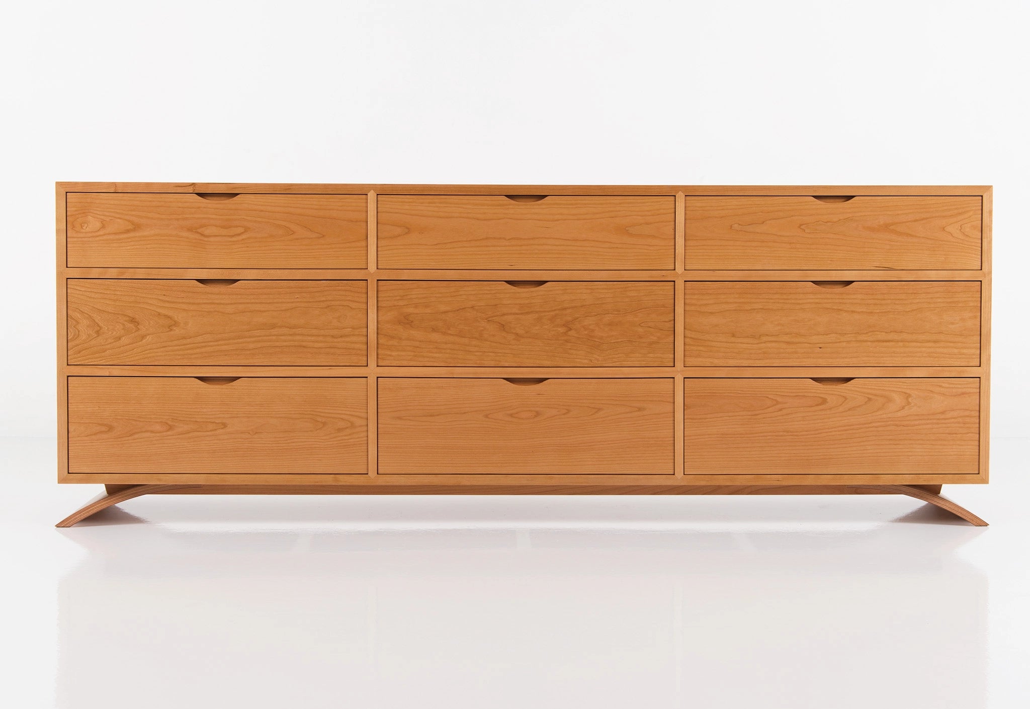 Wooden dresser with multiple drawers on a white background