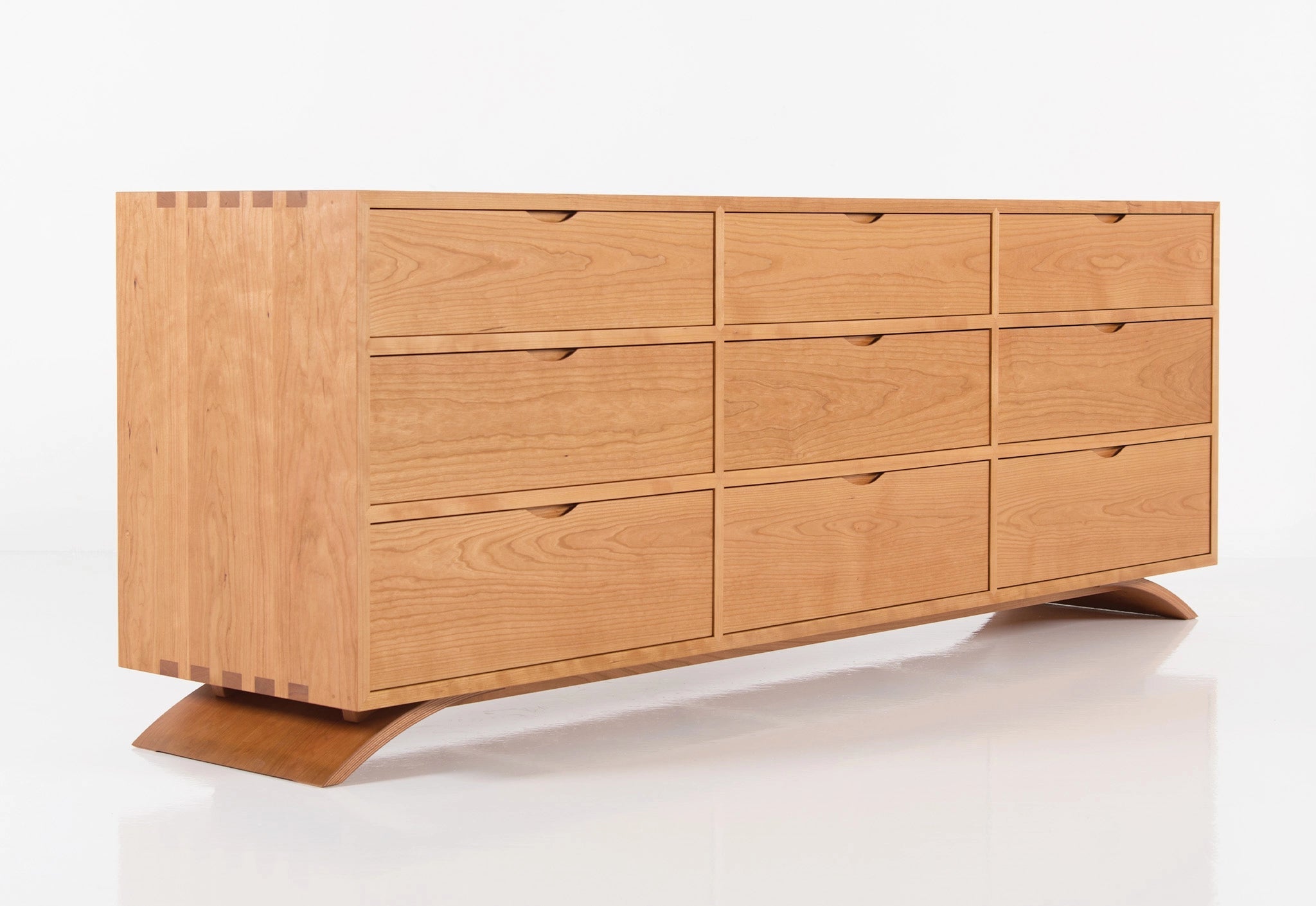 Wooden dresser with multiple drawers on a white background