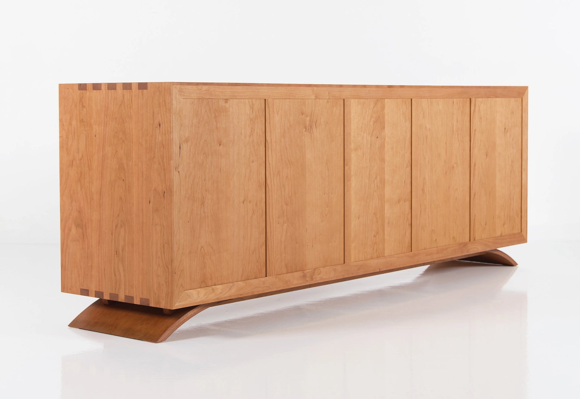 Wooden dresser with a modern design on a white background