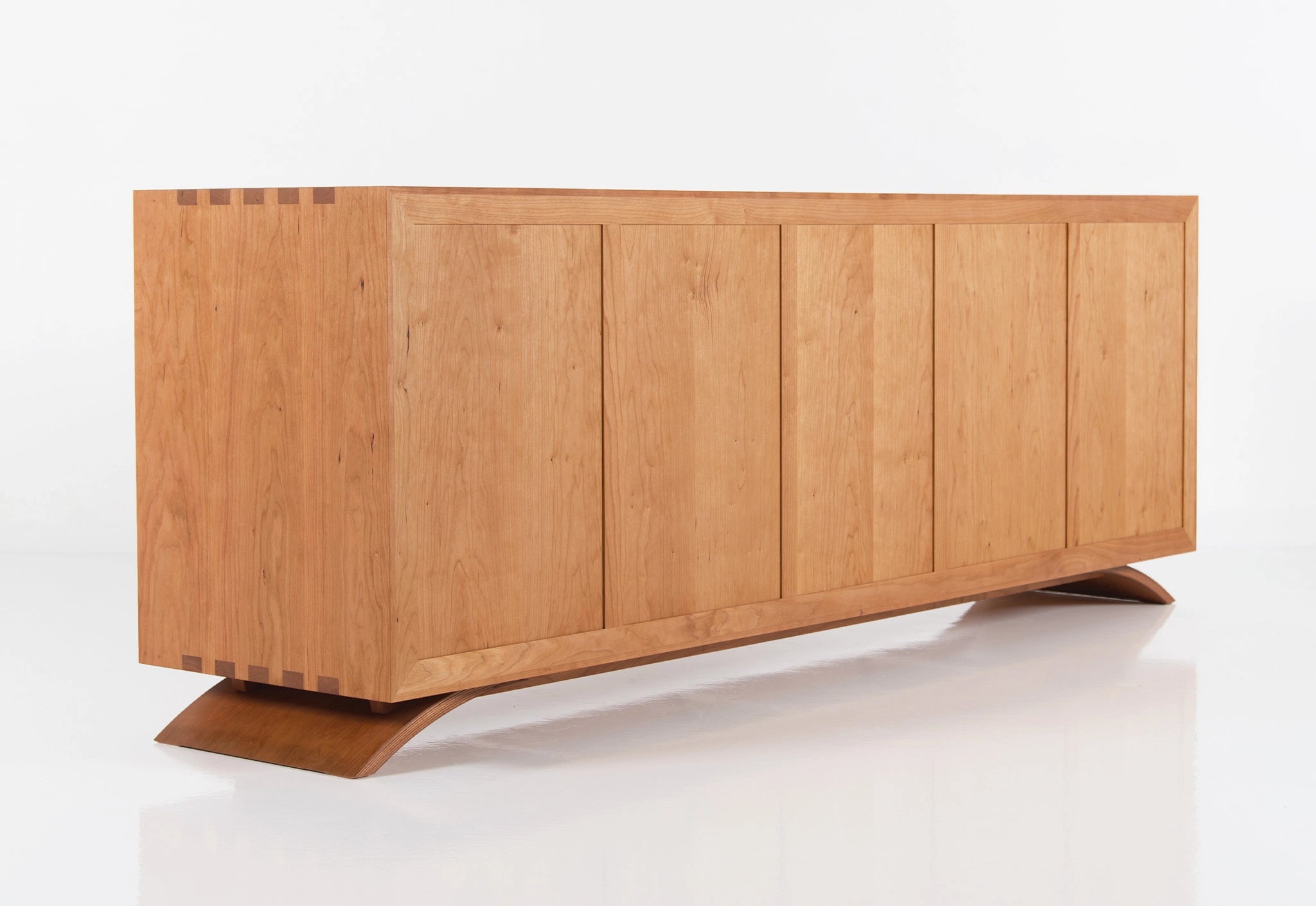Wooden dresser with a modern design on a white background