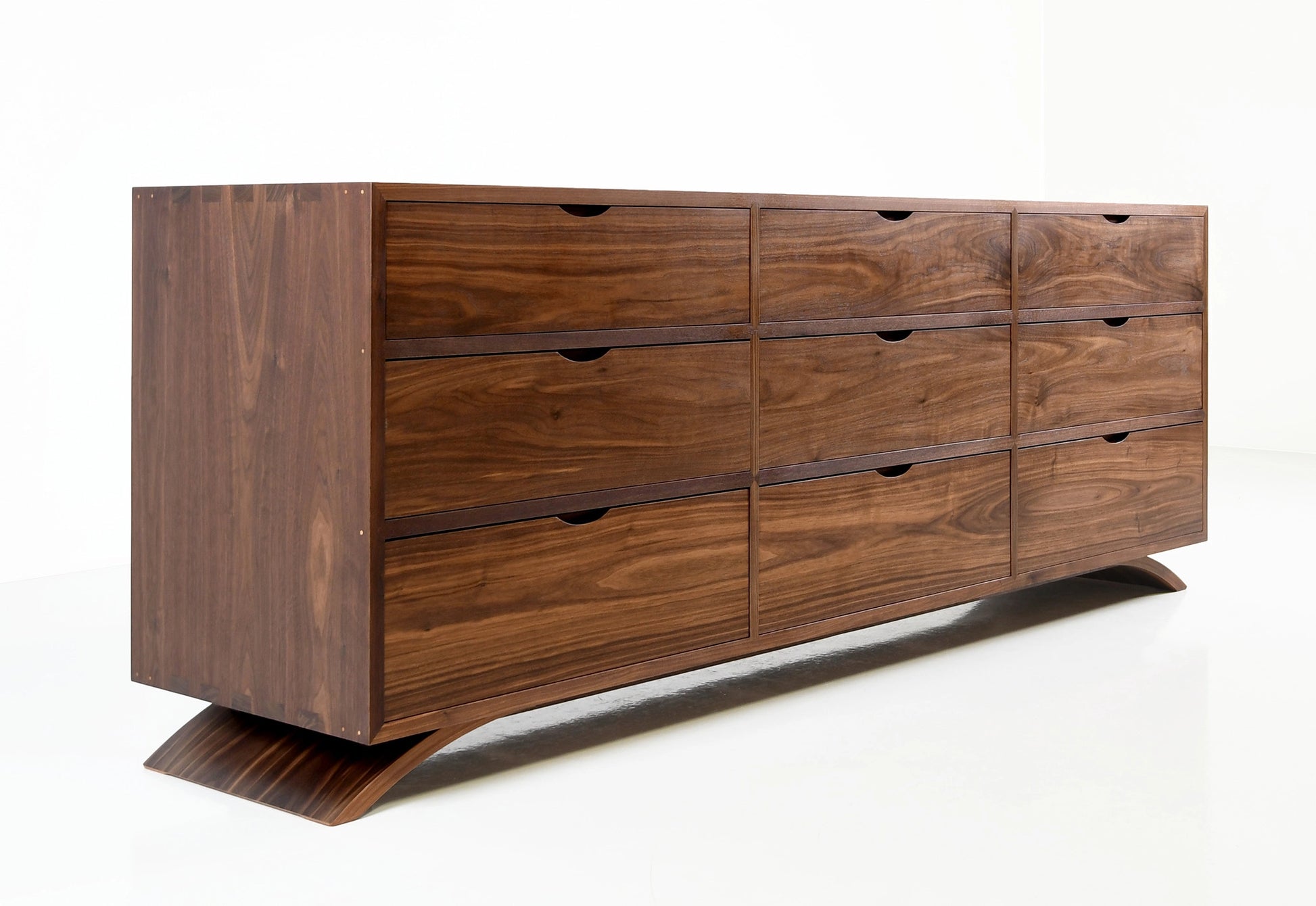 Wooden dresser with multiple drawers on a white background
