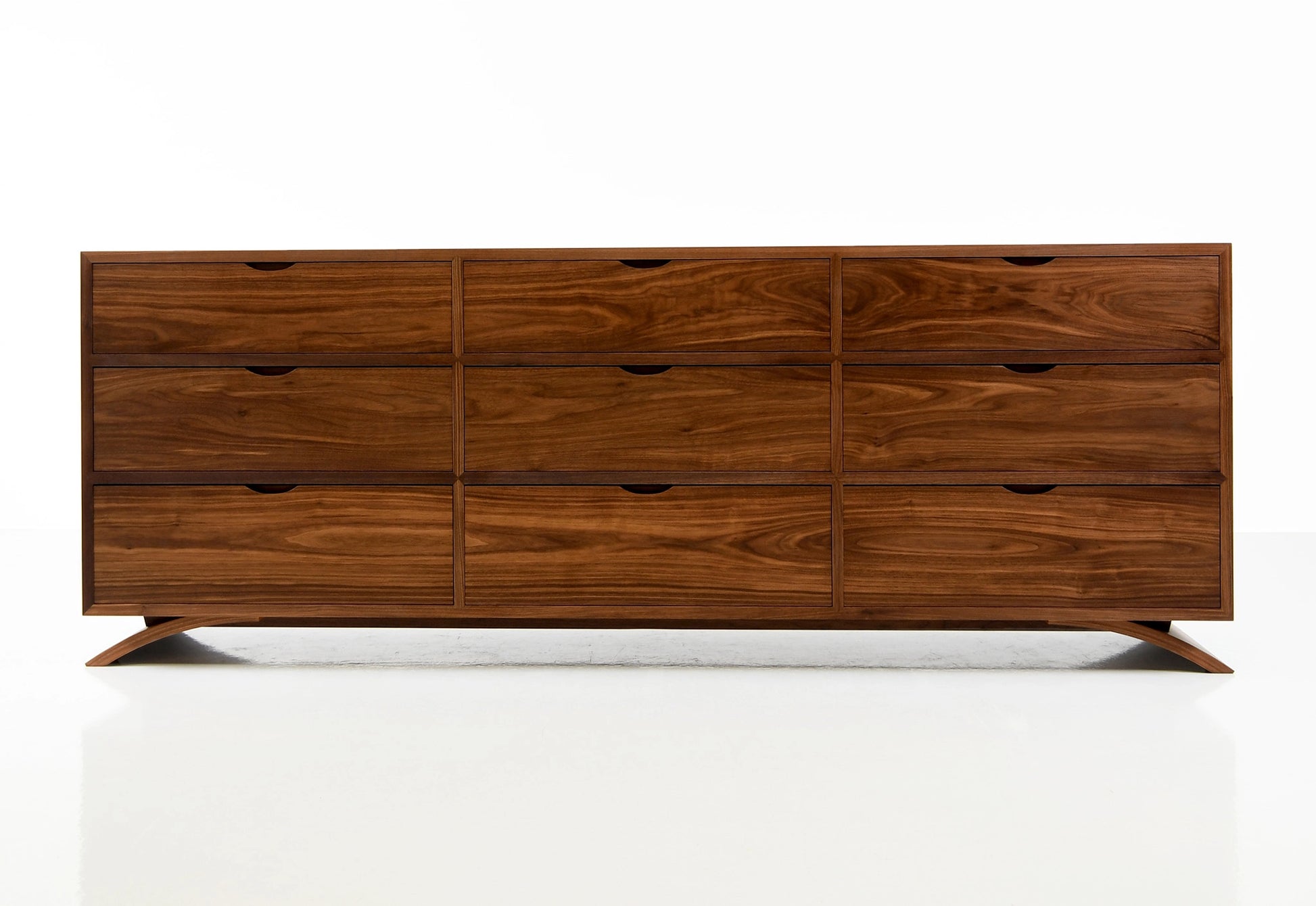 Wooden dresser with multiple drawers on a white background