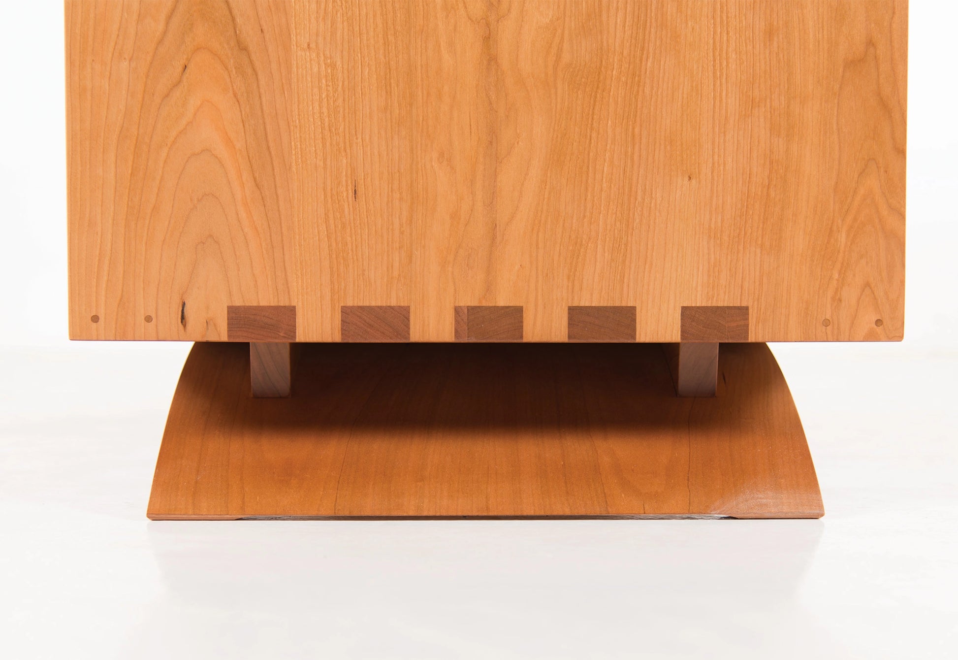 Wooden cabinet with a flat top and square base on a white background