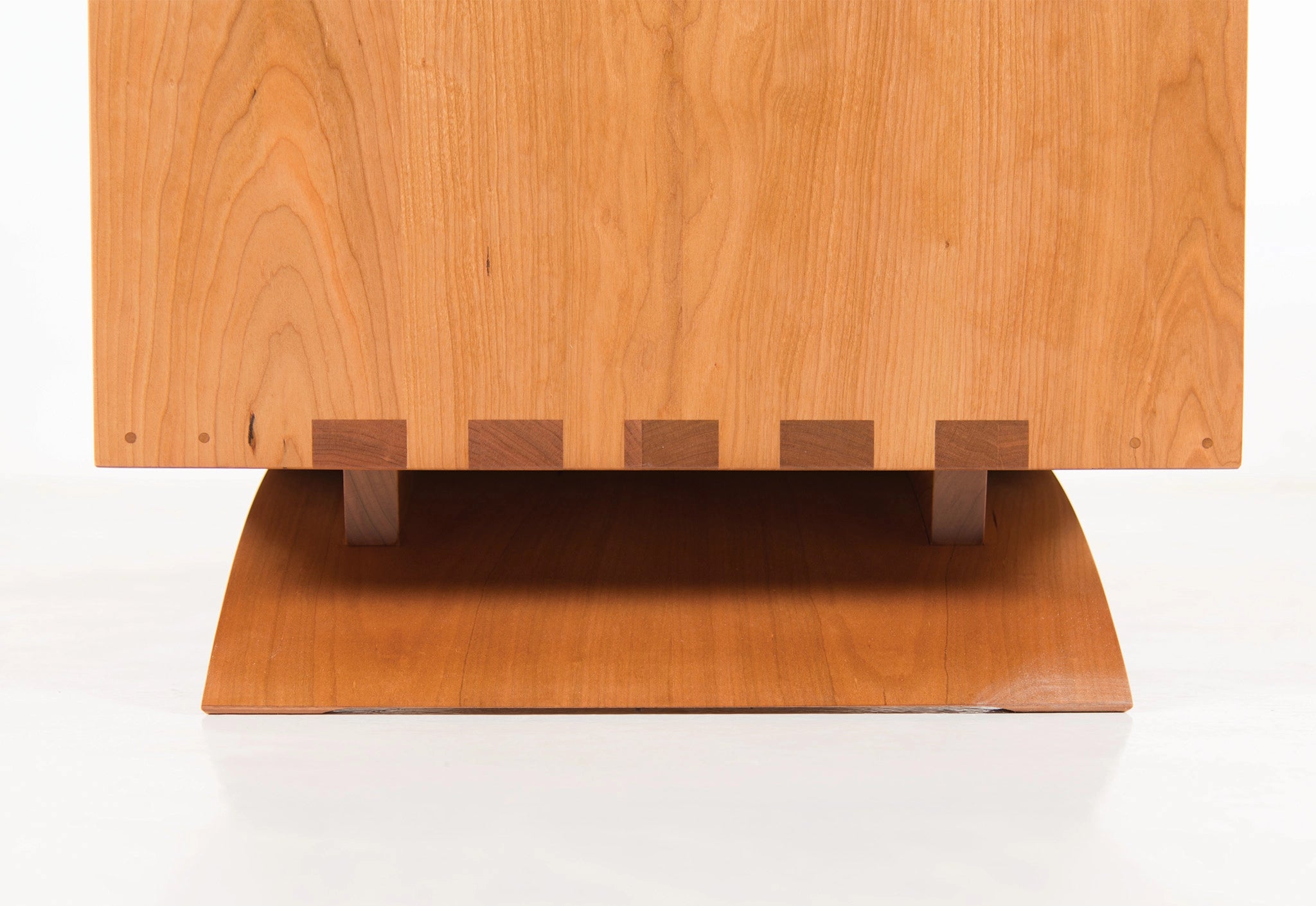 Wooden dresser with a flat top and square base on a white background