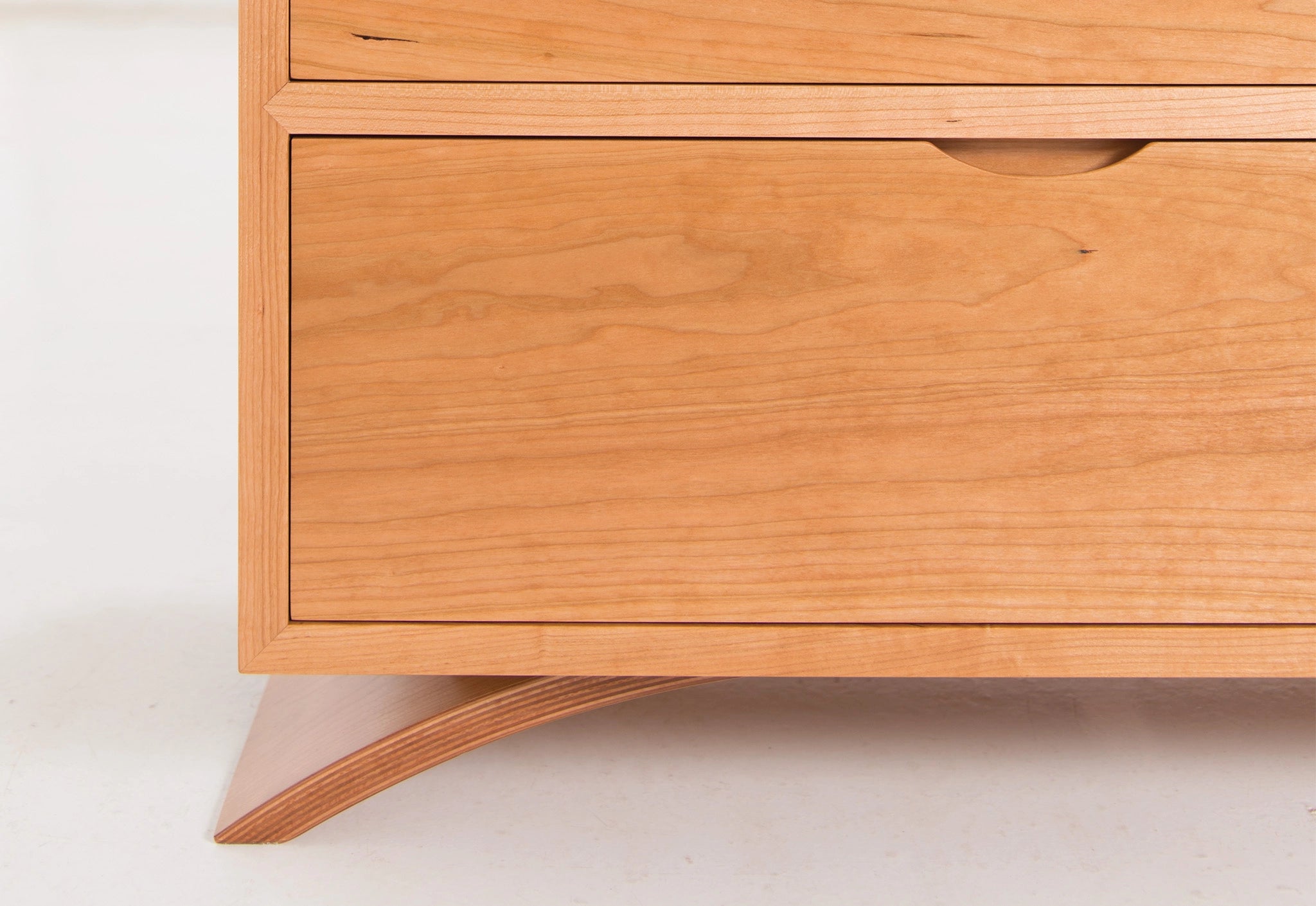 Wooden dresser with a light finish on a white background