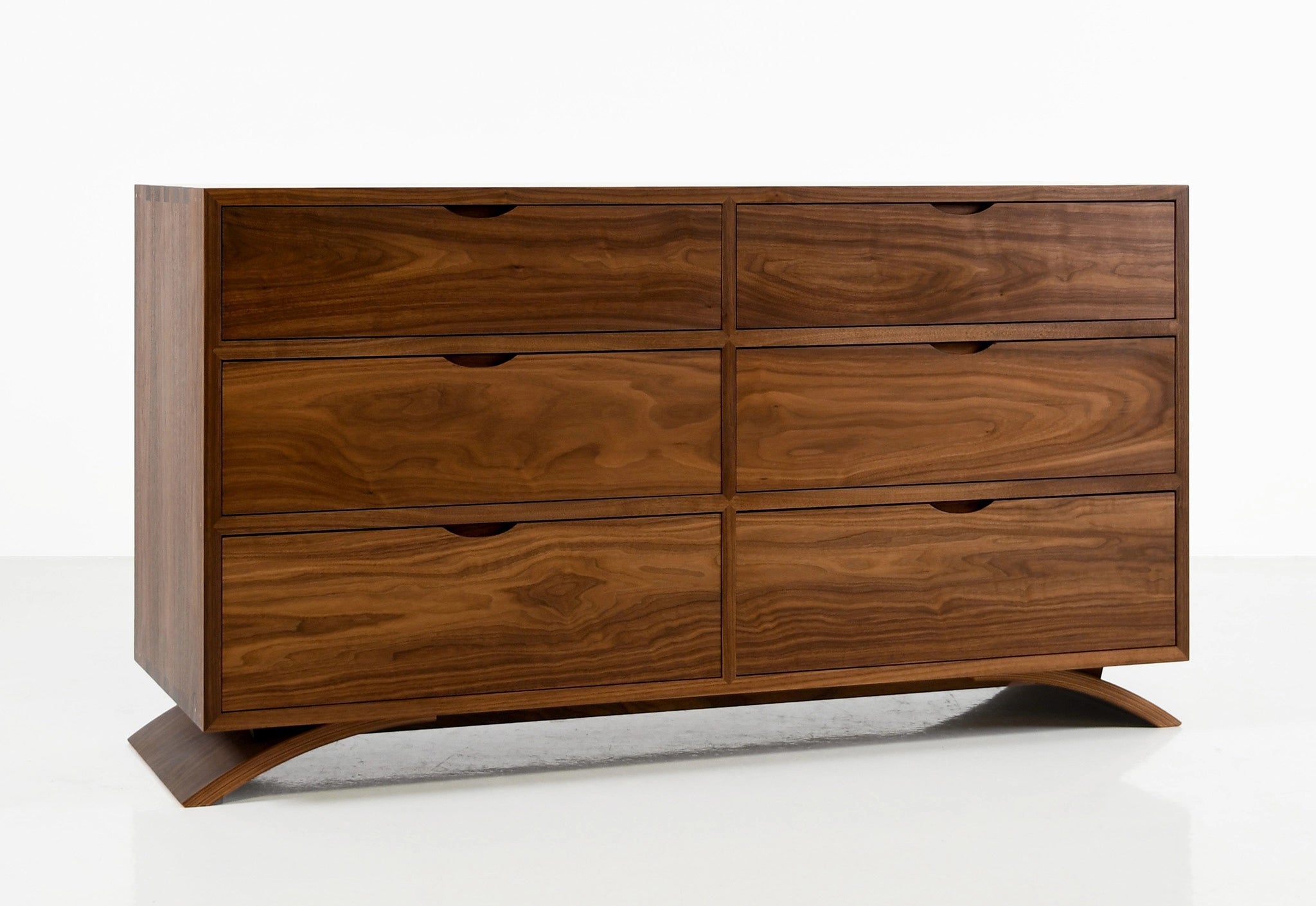 Wooden dresser with multiple drawers on a white background