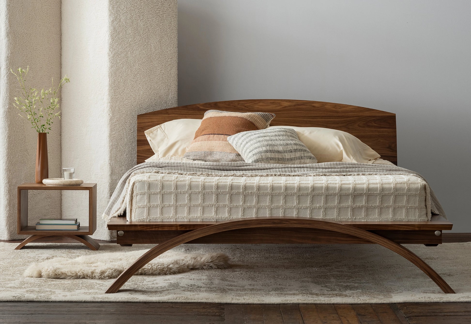 Wooden bed with bedding in a bedroom setting