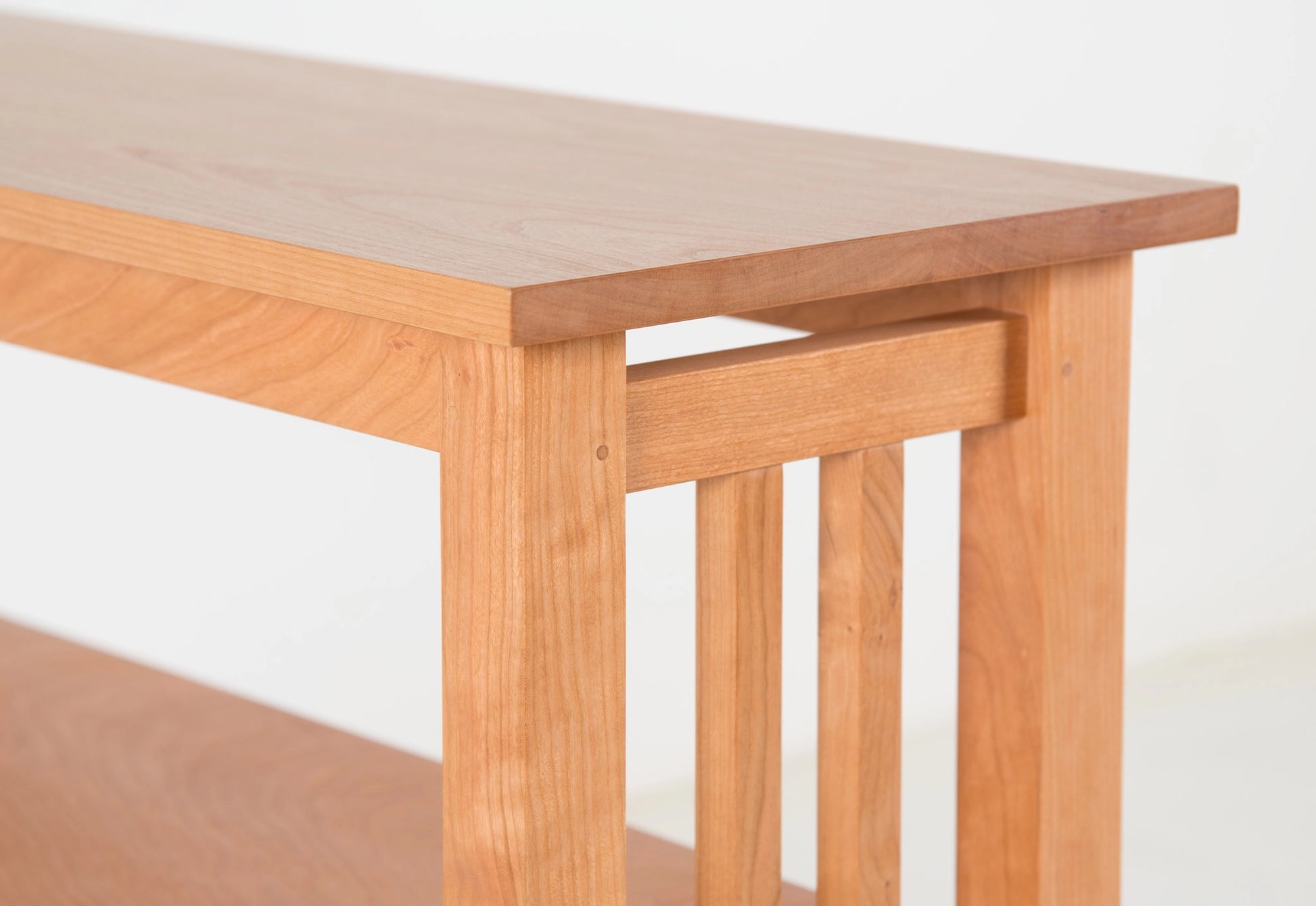 Wooden table with a light finish on a white background