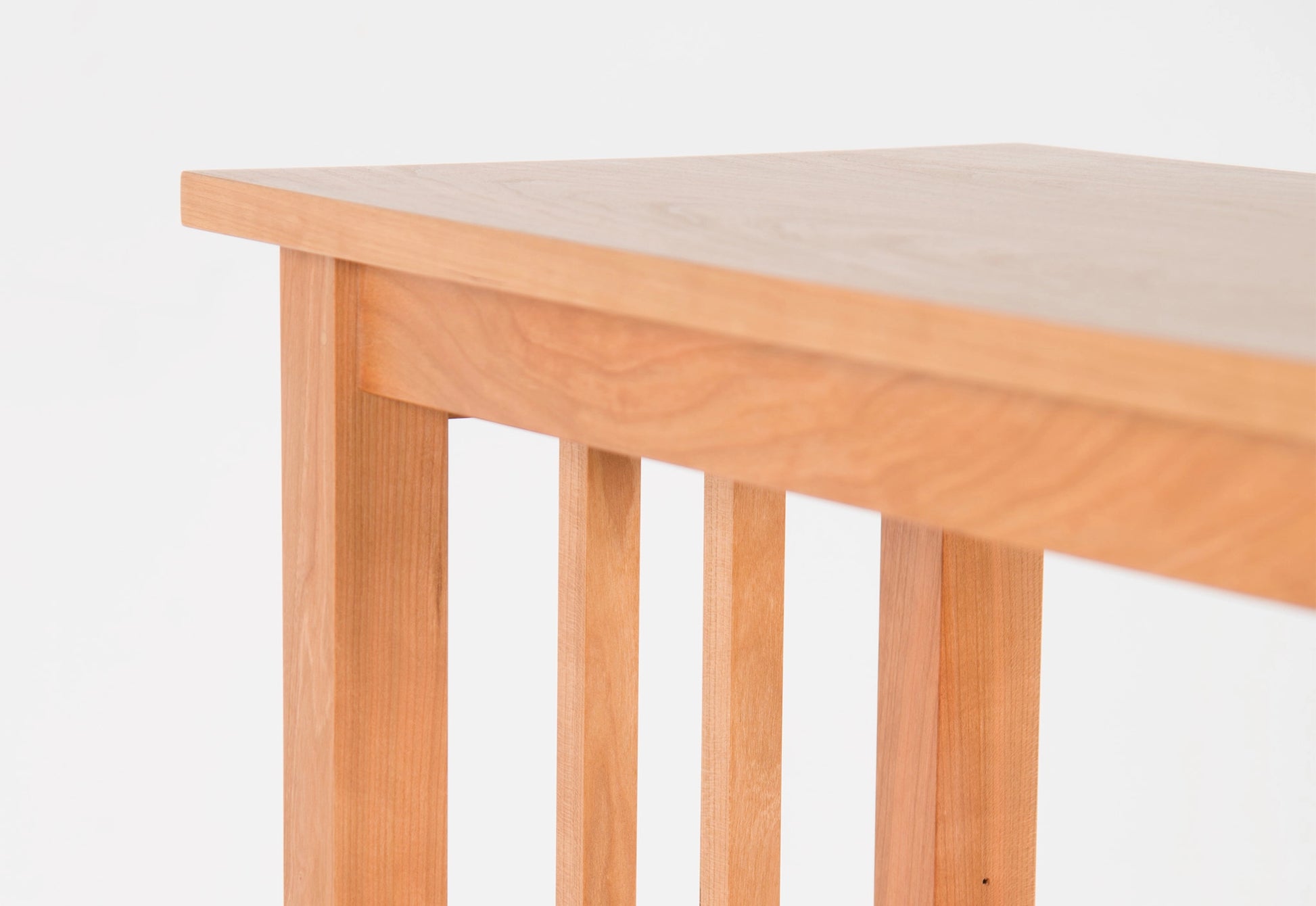 Wooden table with a light finish on a white background