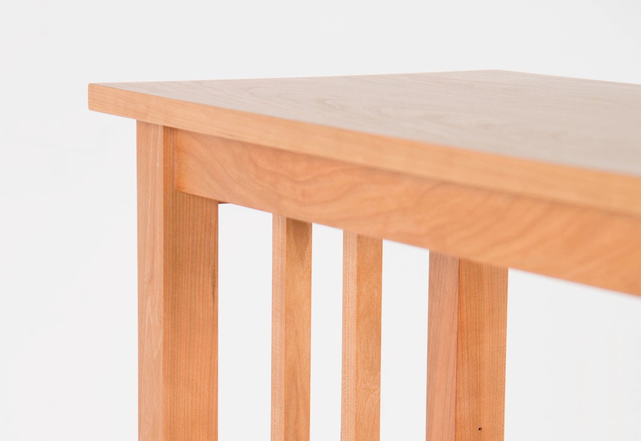 Wooden table with a light finish on a white background