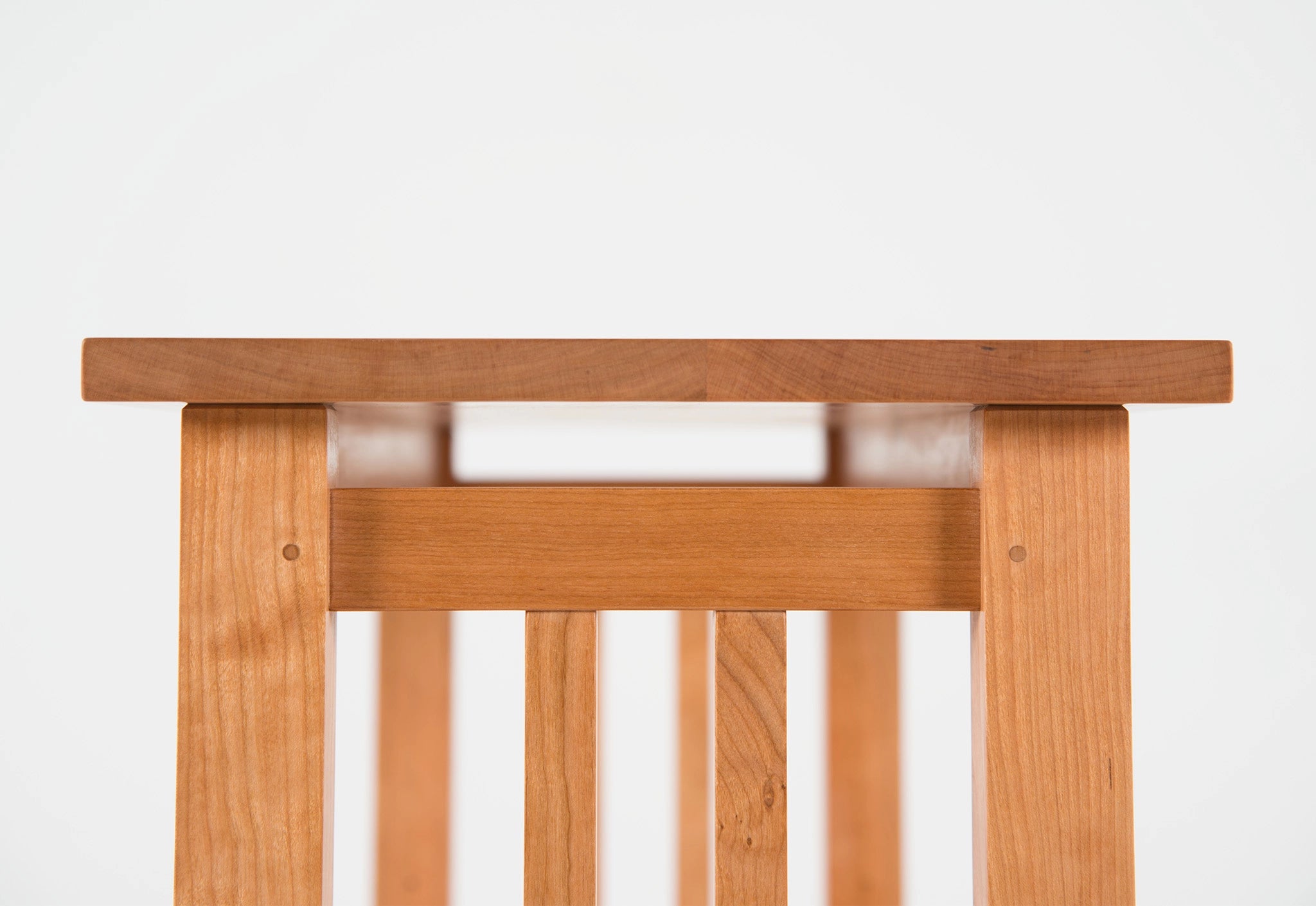 Wooden bed frame with slatted design on a white background