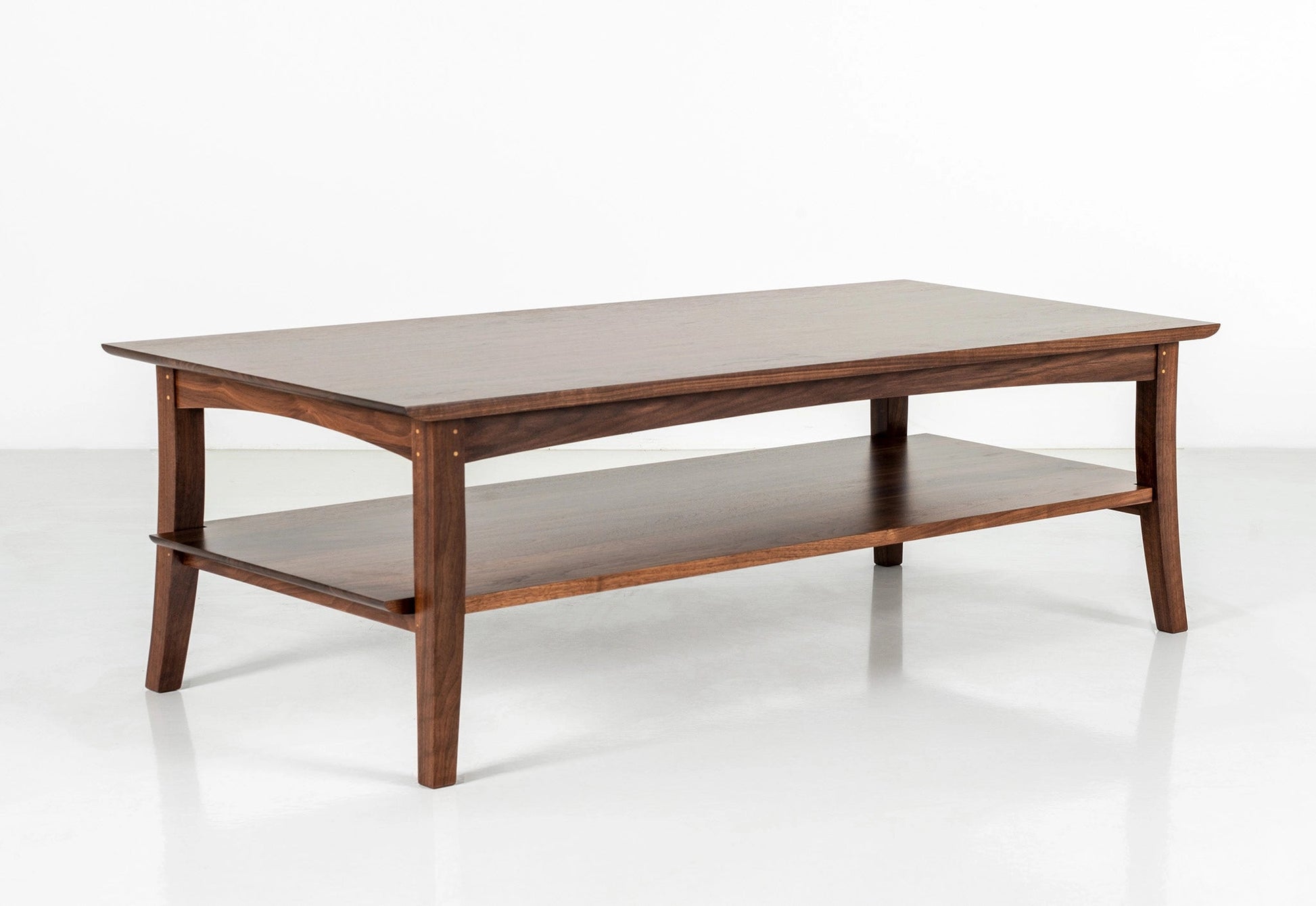 Wooden coffee table with a shelf on a white background