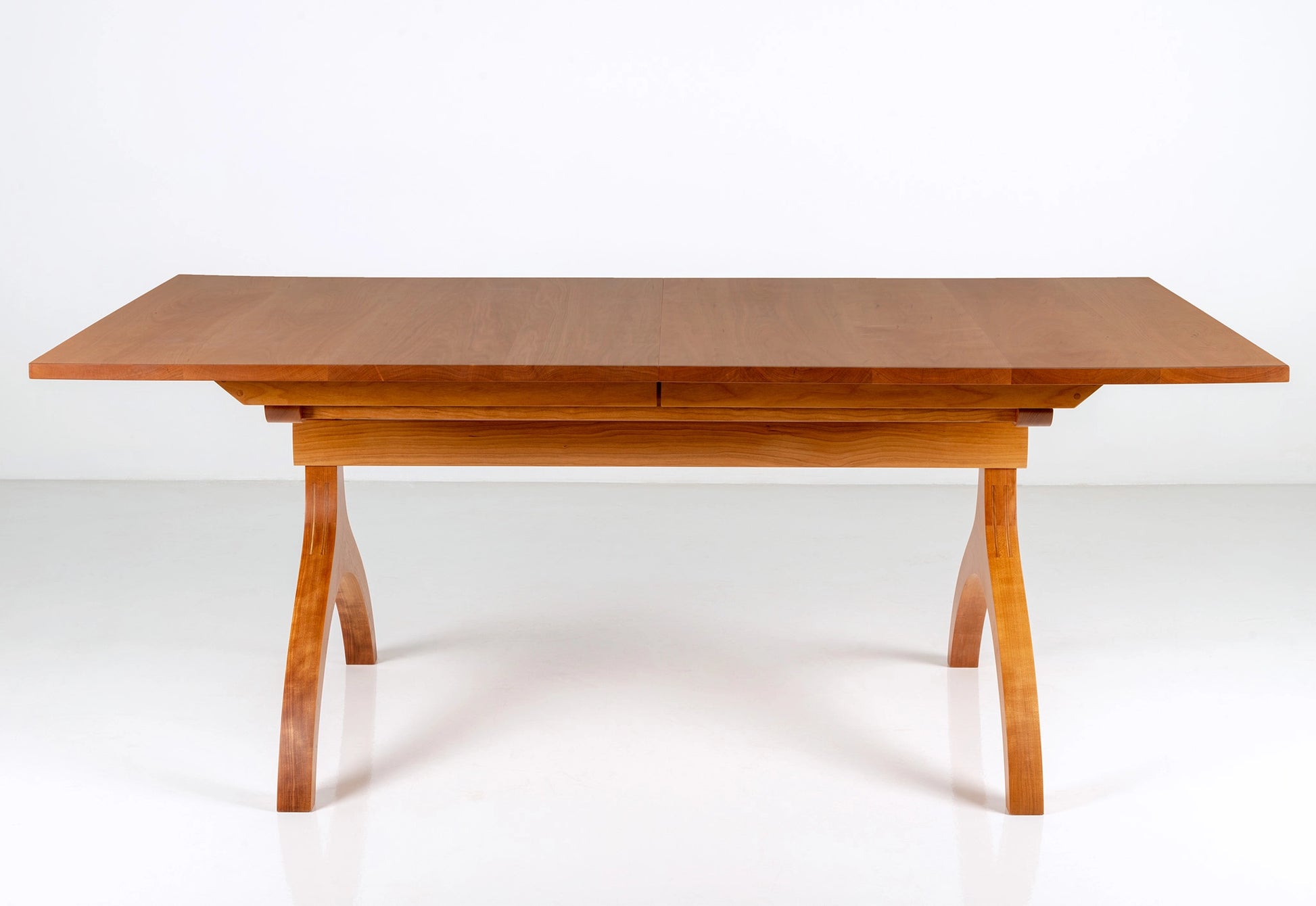 Wooden dining table on a white background