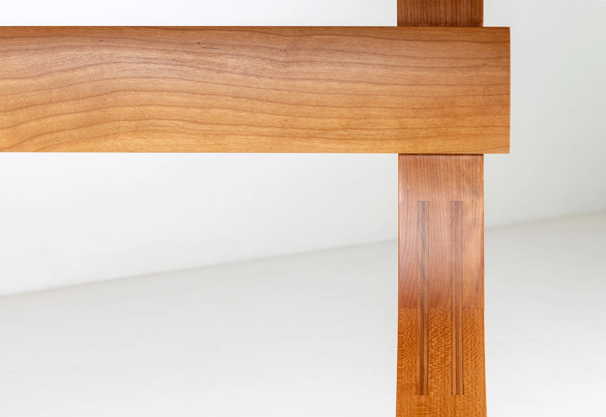 Close-up of a wooden table leg on a white background