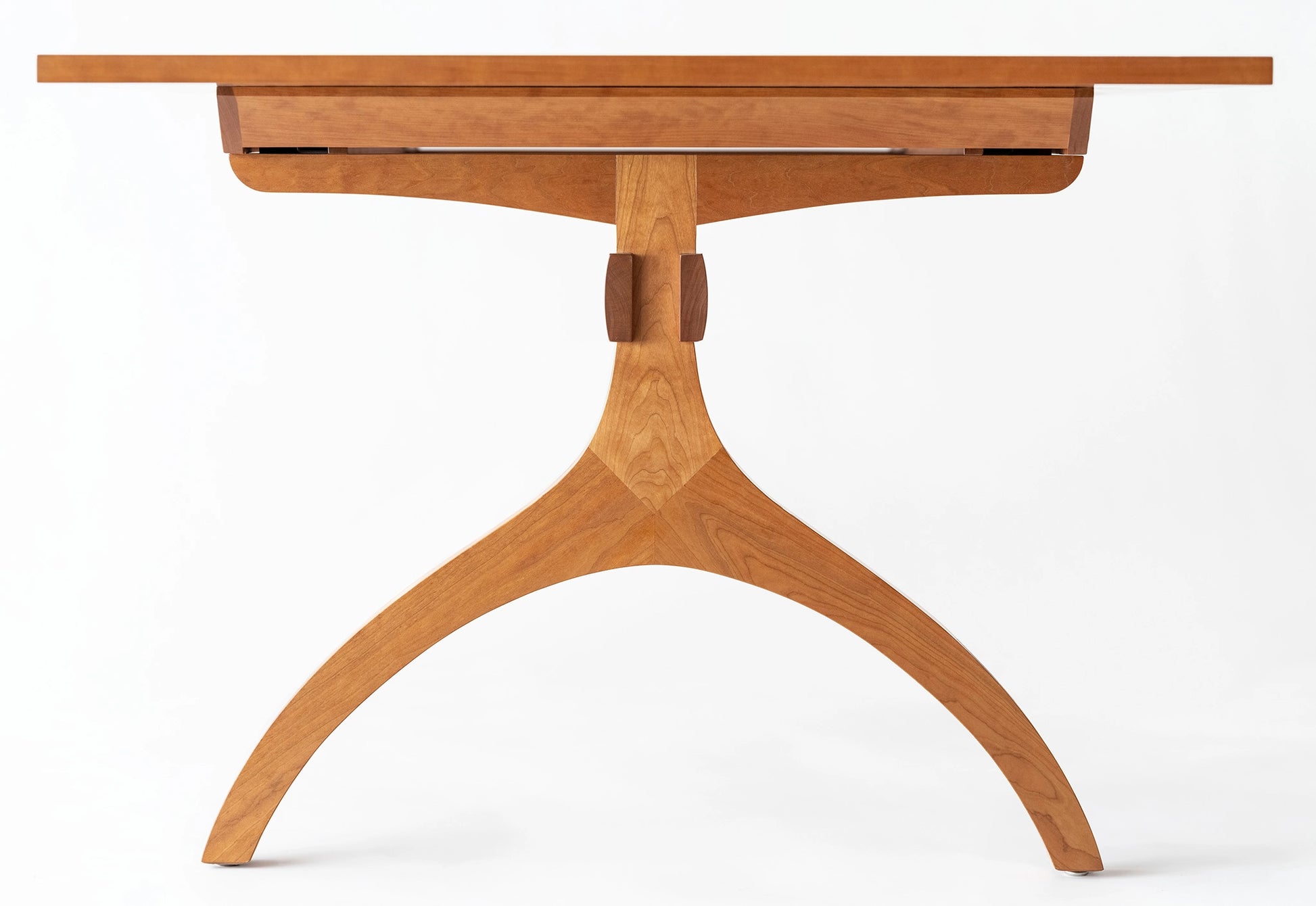 Wooden table with a single leg on a white background